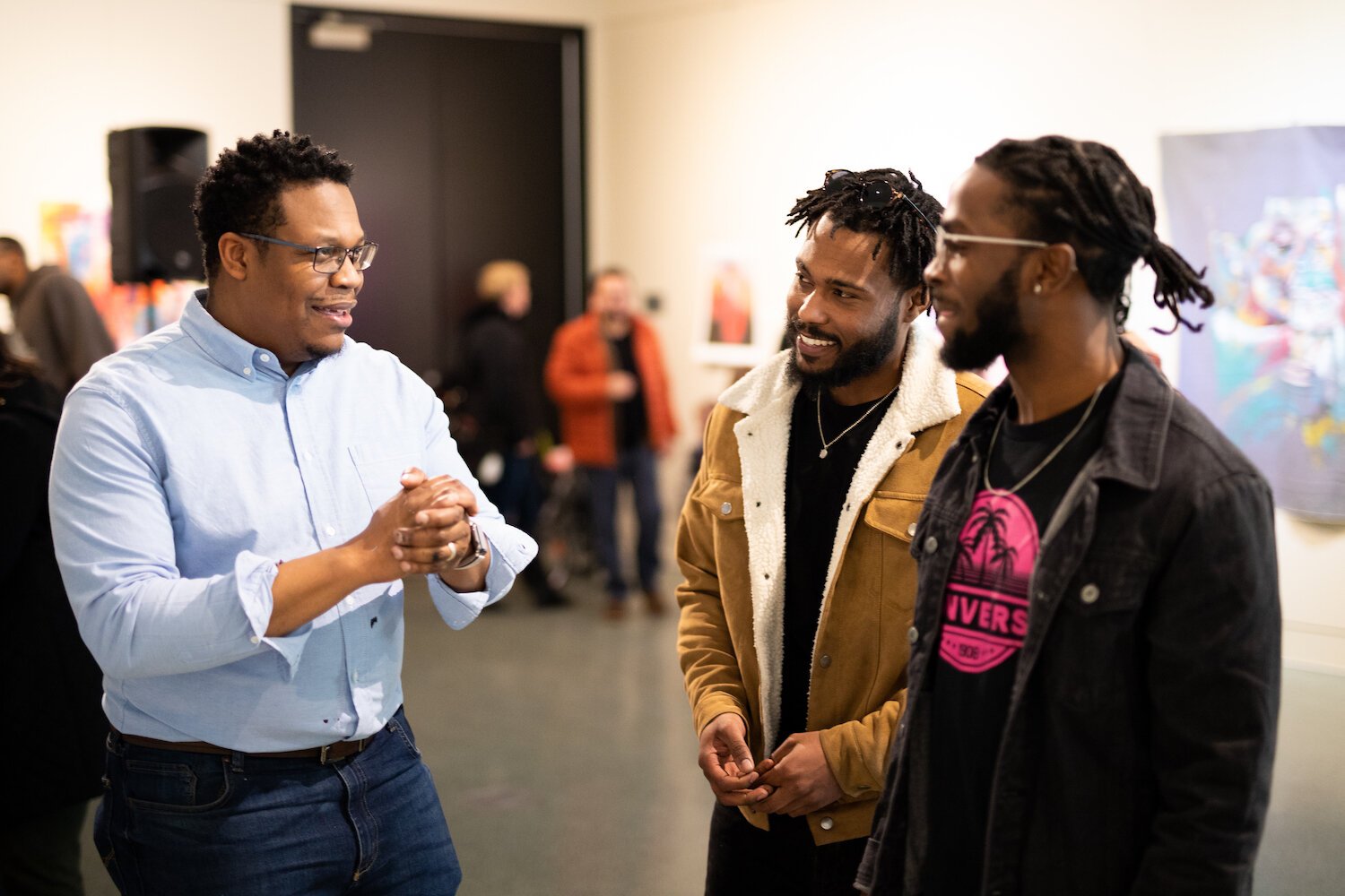 Artist Theopolis Smith III speaks to attendees at at the Jeffrey R. Krull Art Gallery.