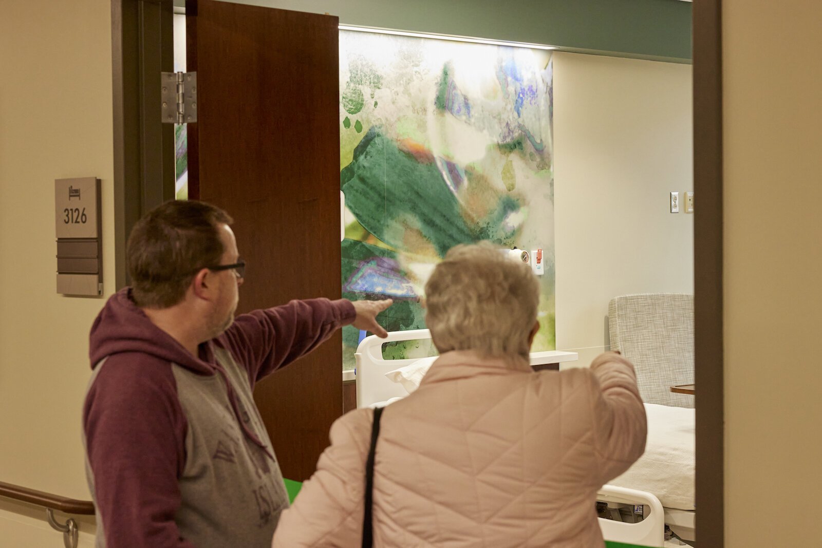 Open house guests view a patient room in the new Parkview Kosciusko Hospital, which includes a mural painted by a local artist.
