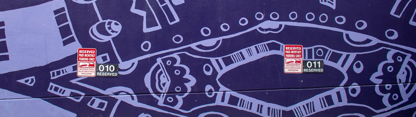 A mural on the parking garage that borders the TriCore Porch Off Calhoun.