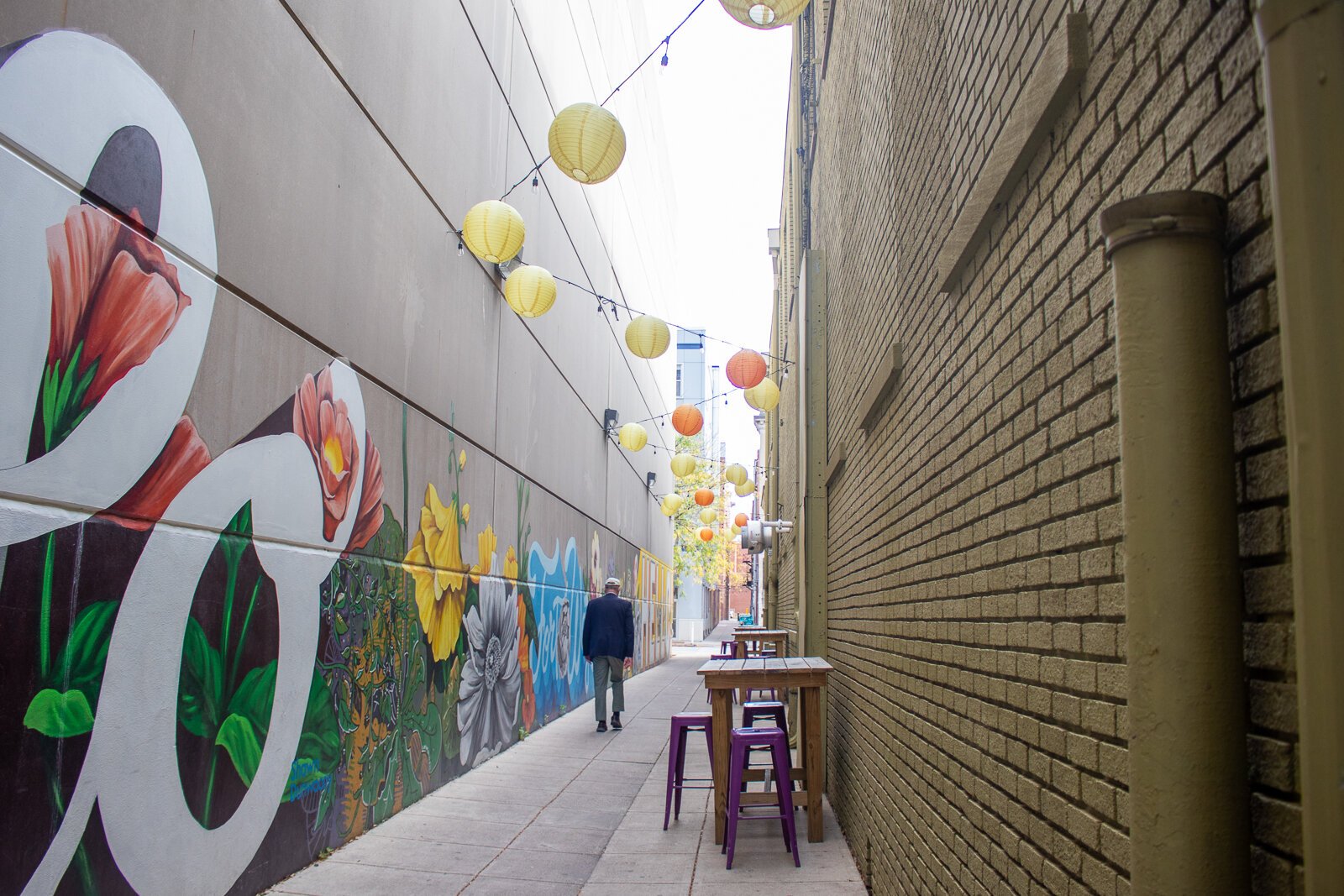 Seats and tables line the alleys near the TriCore Porch Off Calhoun.