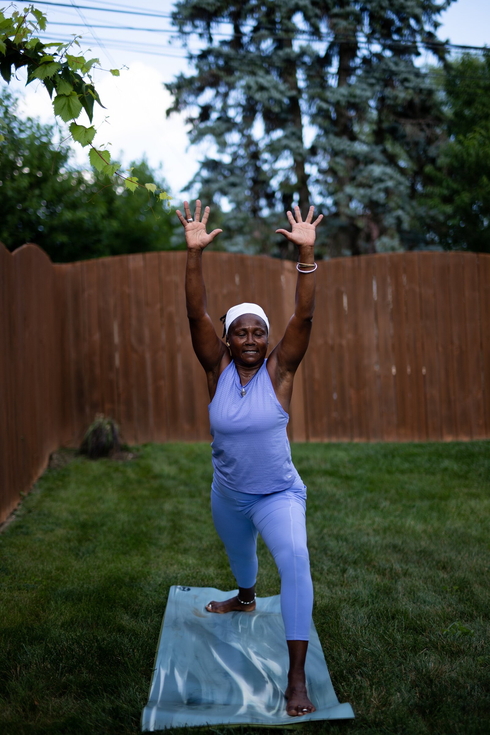 Diane Rogers, a longtime resident and current President of the Oxford Community Association, leads a yoga class in her backyard for her neighborhood and community drop-ins.