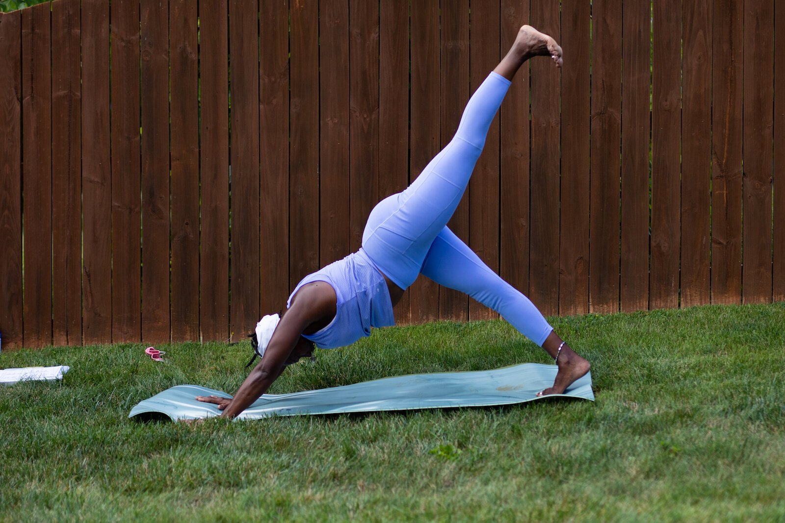 Diane Rogers, a longtime resident and current President of the Oxford Community Association, leads a yoga class in her backyard for her neighborhood and community drop-ins.