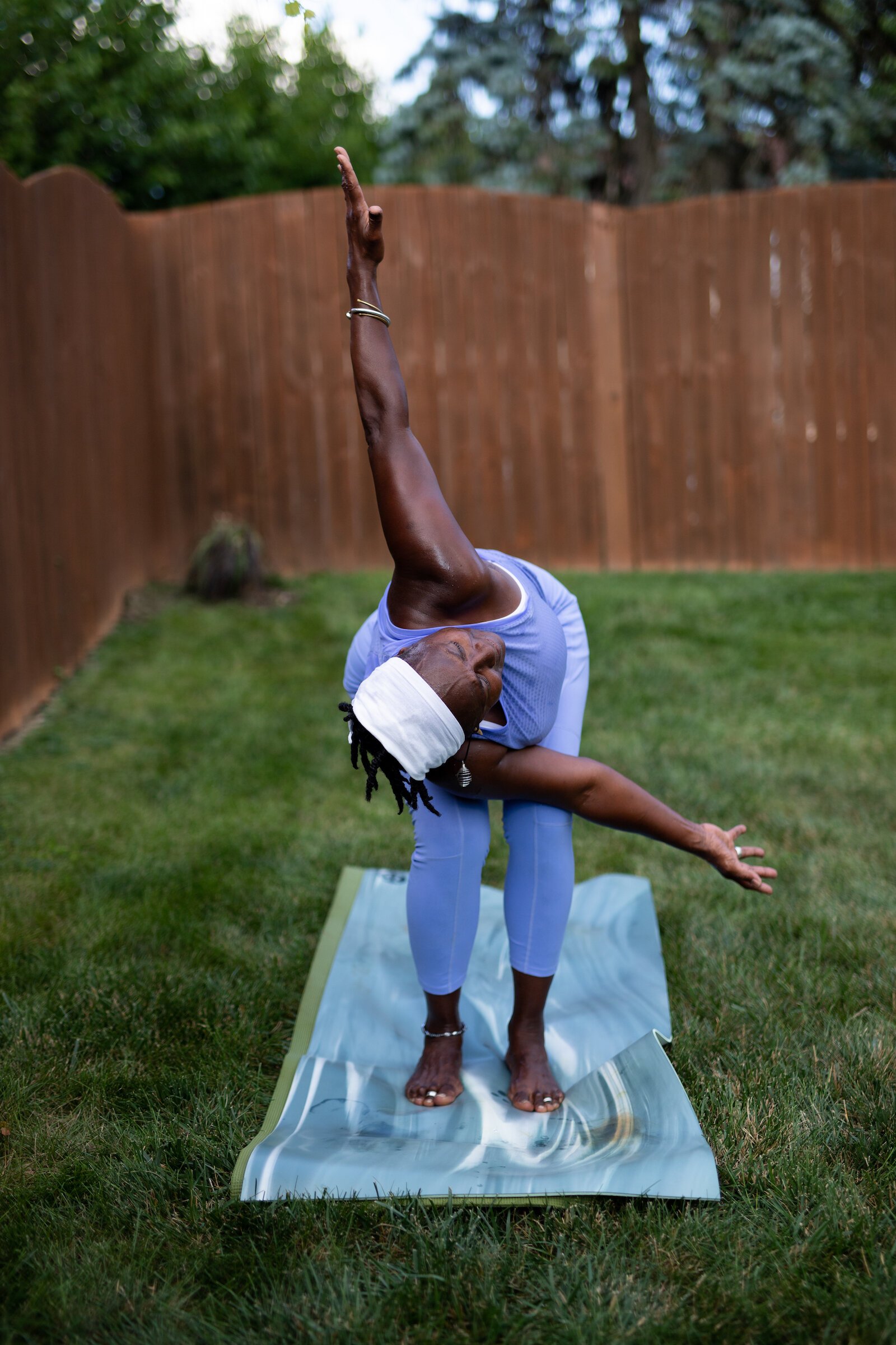 Diane Rogers, a longtime resident and current President of the Oxford Community Association, leads a yoga class in her backyard for her neighborhood and community drop-ins.