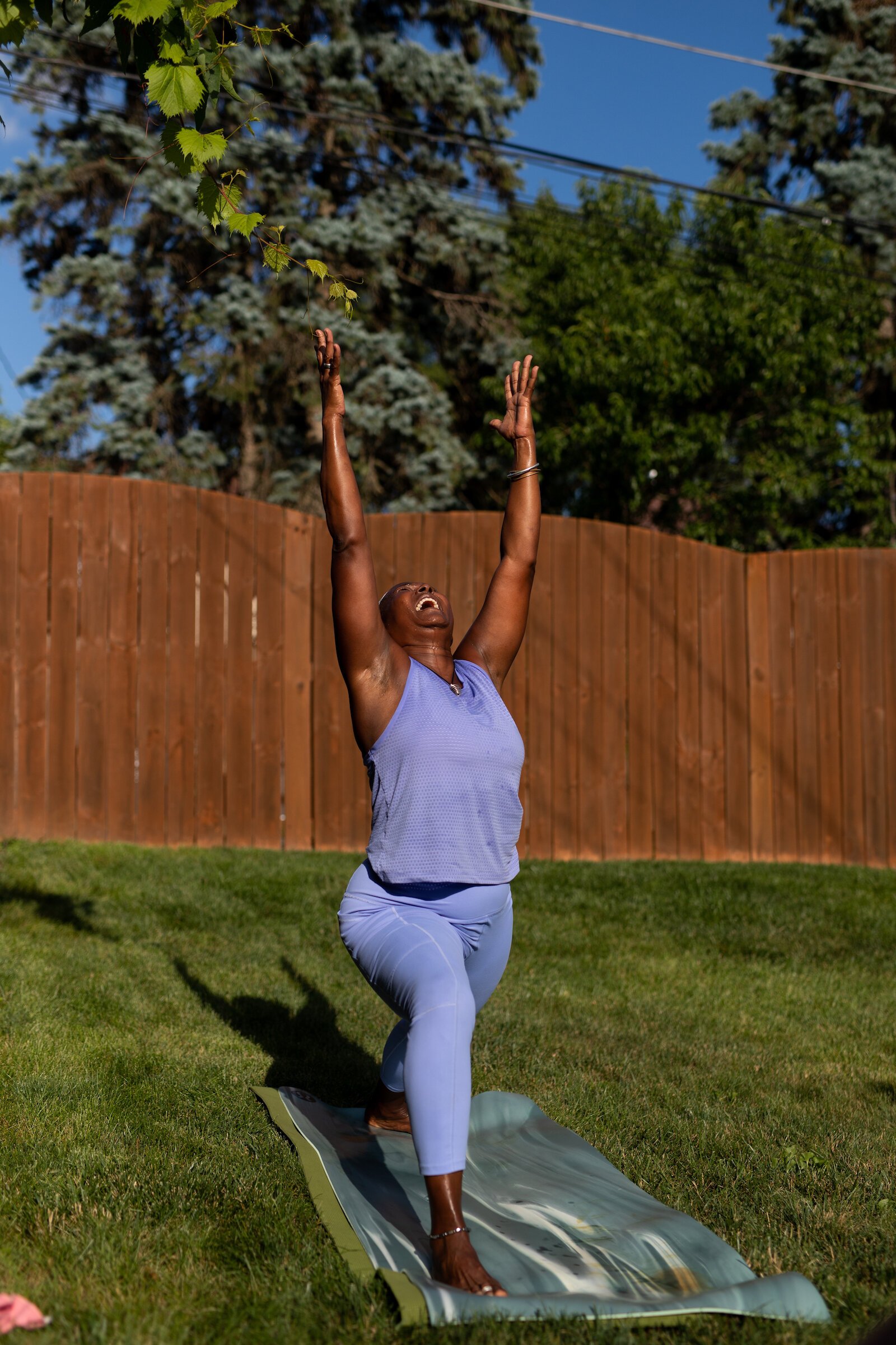 Diane Rogers, a longtime resident and current President of the Oxford Community Association, leads a yoga class in her backyard for her neighborhood and community drop-ins.