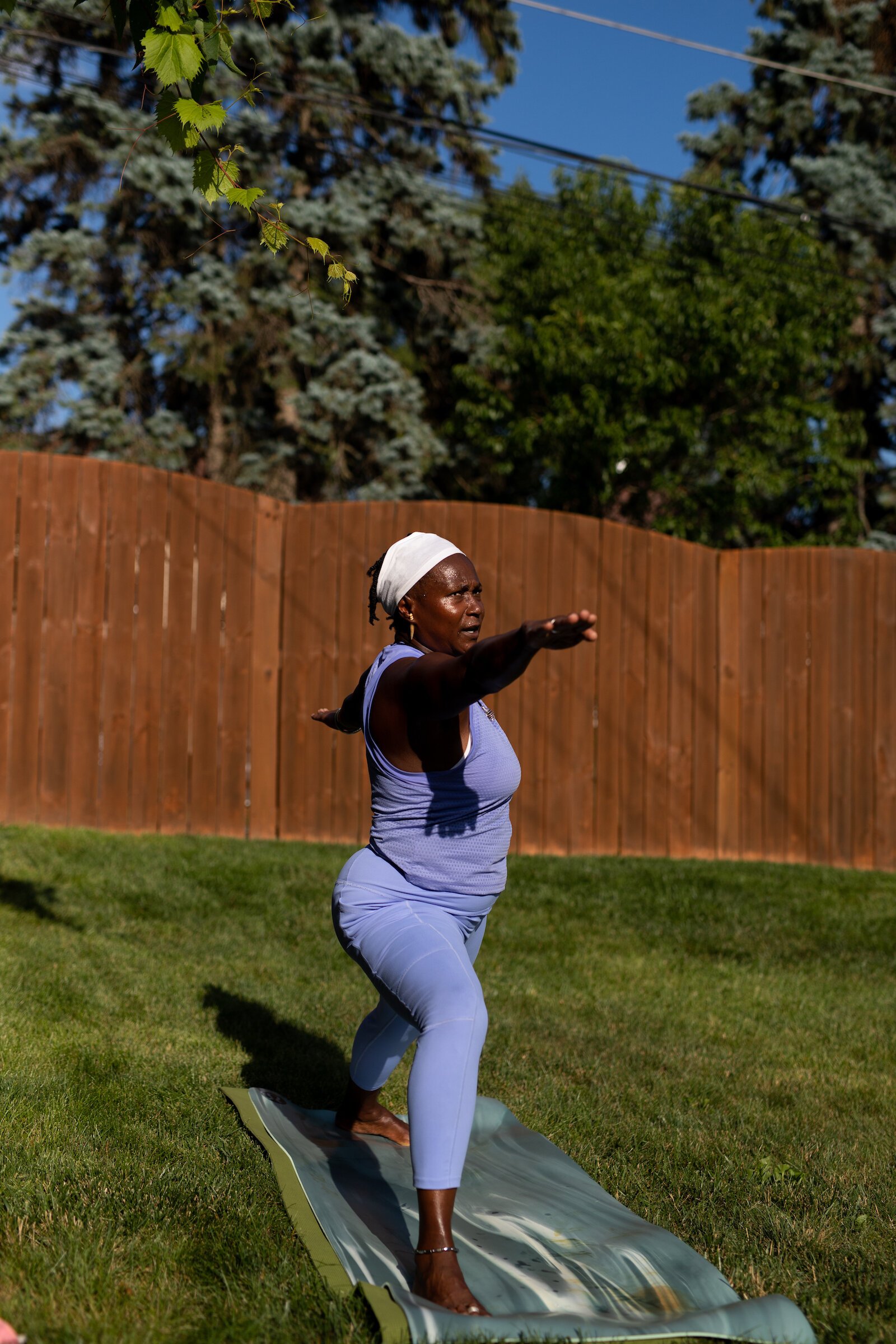 Diane Rogers, a longtime resident and current President of the Oxford Community Association, leads a yoga class in her backyard for her neighborhood and community drop-ins.