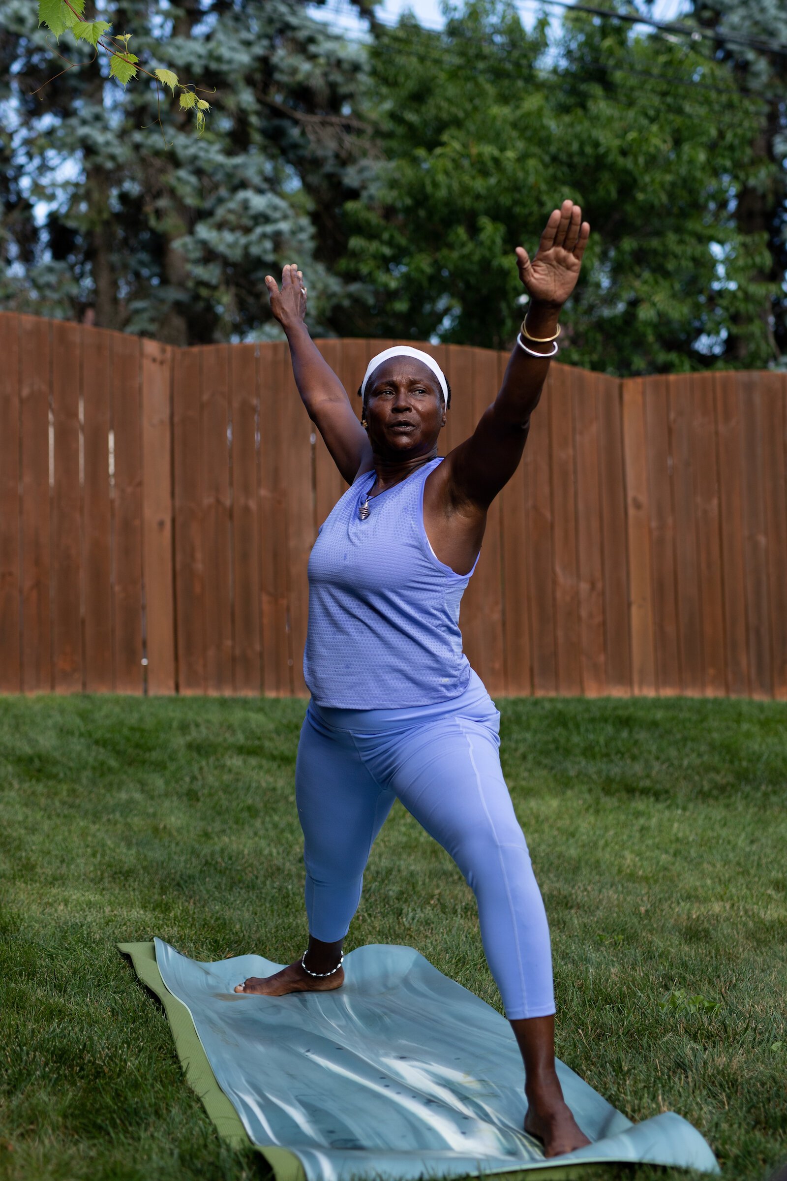 Diane Rogers, a longtime resident and current President of the Oxford Community Association, leads a yoga class in her backyard for her neighborhood and community drop-ins.