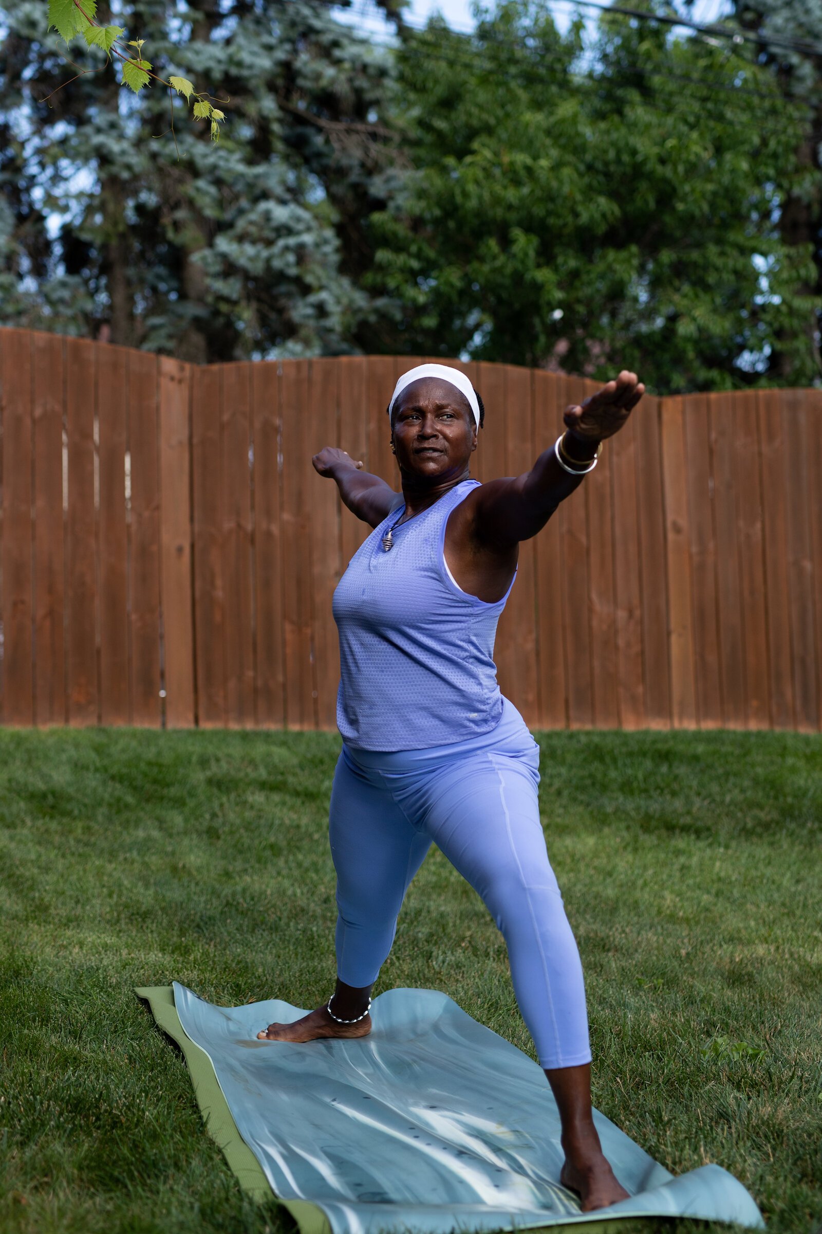 Diane Rogers, a longtime resident and current President of the Oxford Community Association, leads a yoga class in her backyard for her neighborhood and community drop-ins.