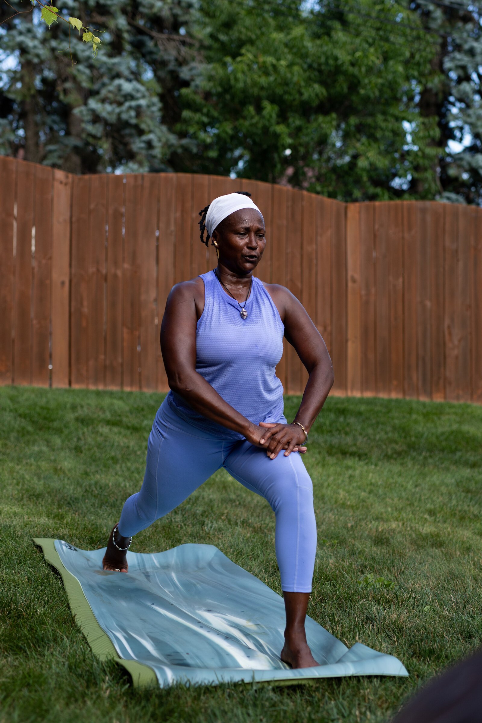 Diane Rogers, a longtime resident and current President of the Oxford Community Association, leads a yoga class in her backyard for her neighborhood and community drop-ins.