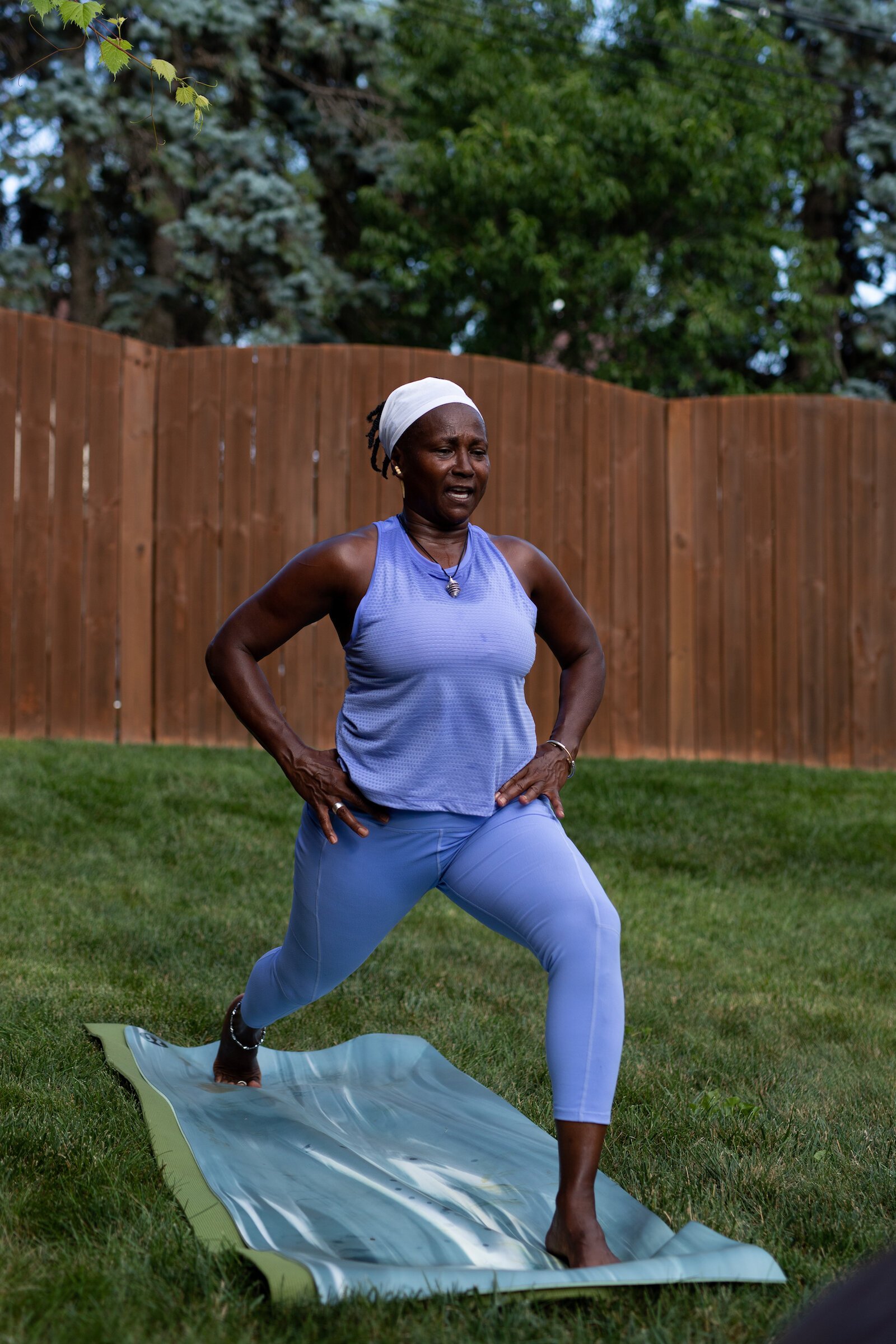 Diane Rogers, a longtime resident and current President of the Oxford Community Association, leads a yoga class in her backyard for her neighborhood and community drop-ins.