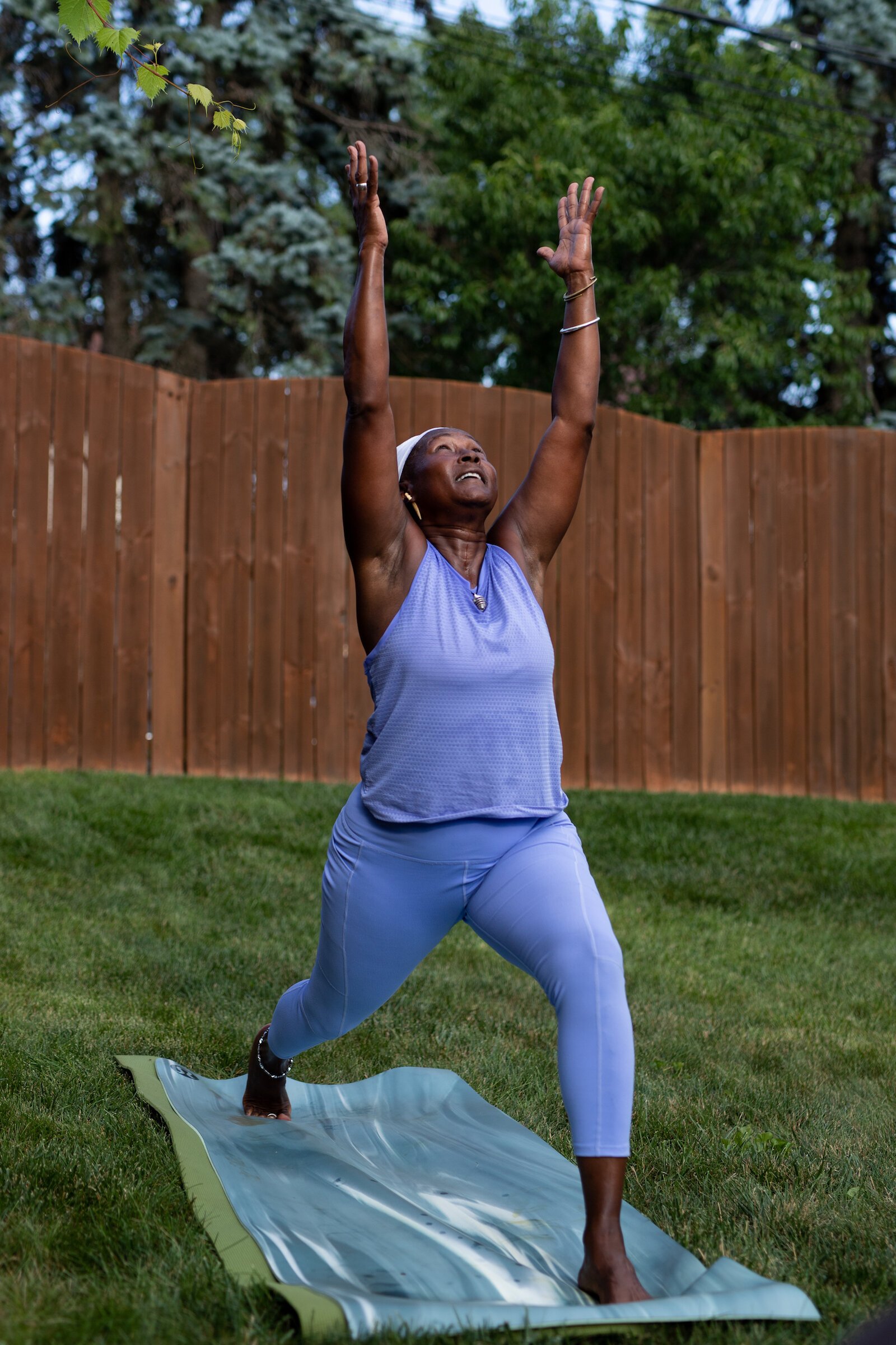 Diane Rogers, a longtime resident and current President of the Oxford Community Association, leads a yoga class in her backyard for her neighborhood and community drop-ins.