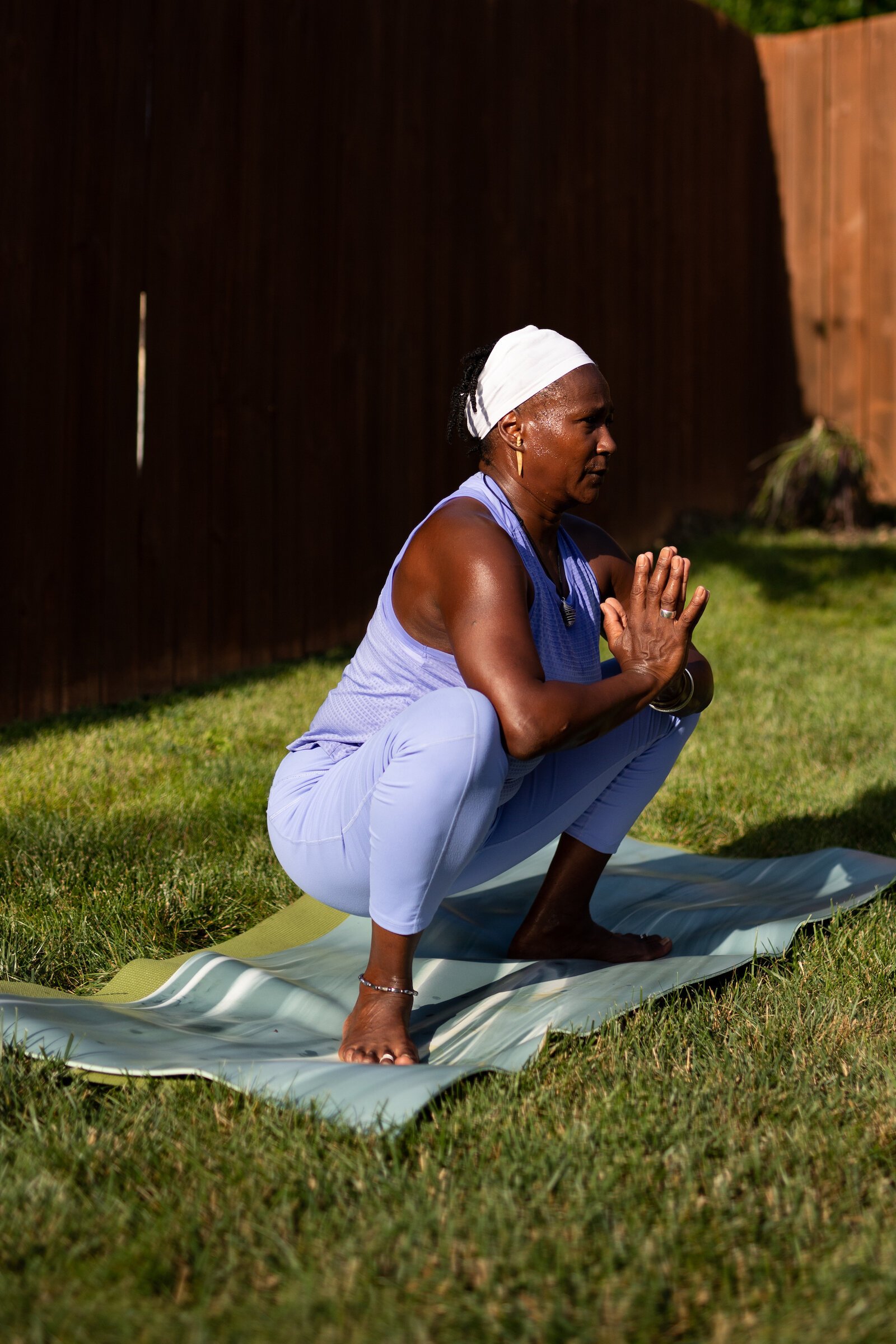 Diane Rogers, a longtime resident and current President of the Oxford Community Association, leads a yoga class in her backyard for her neighborhood and community drop-ins.