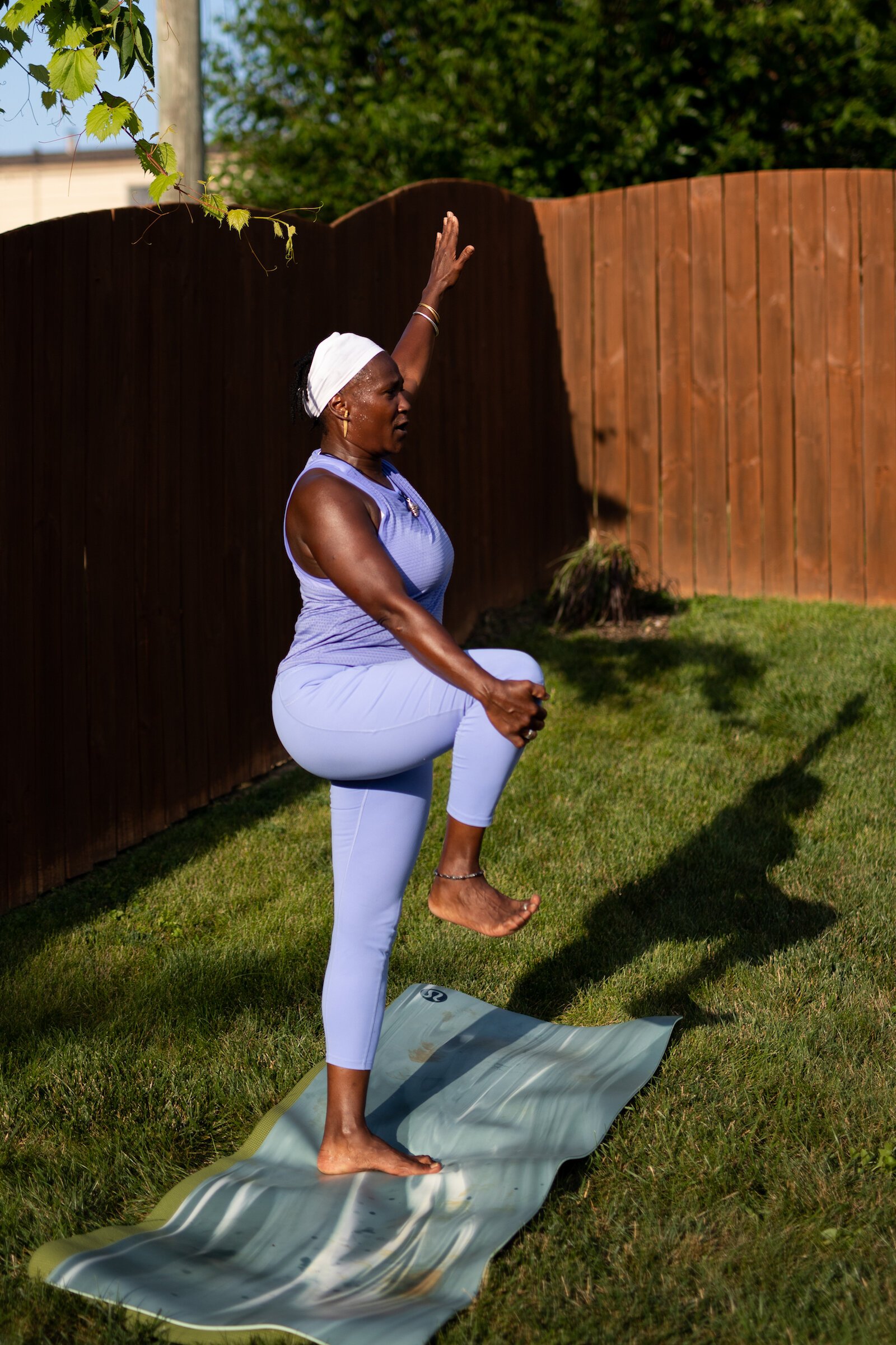 Diane Rogers, a longtime resident and current President of the Oxford Community Association, leads a yoga class in her backyard for her neighborhood and community drop-ins.