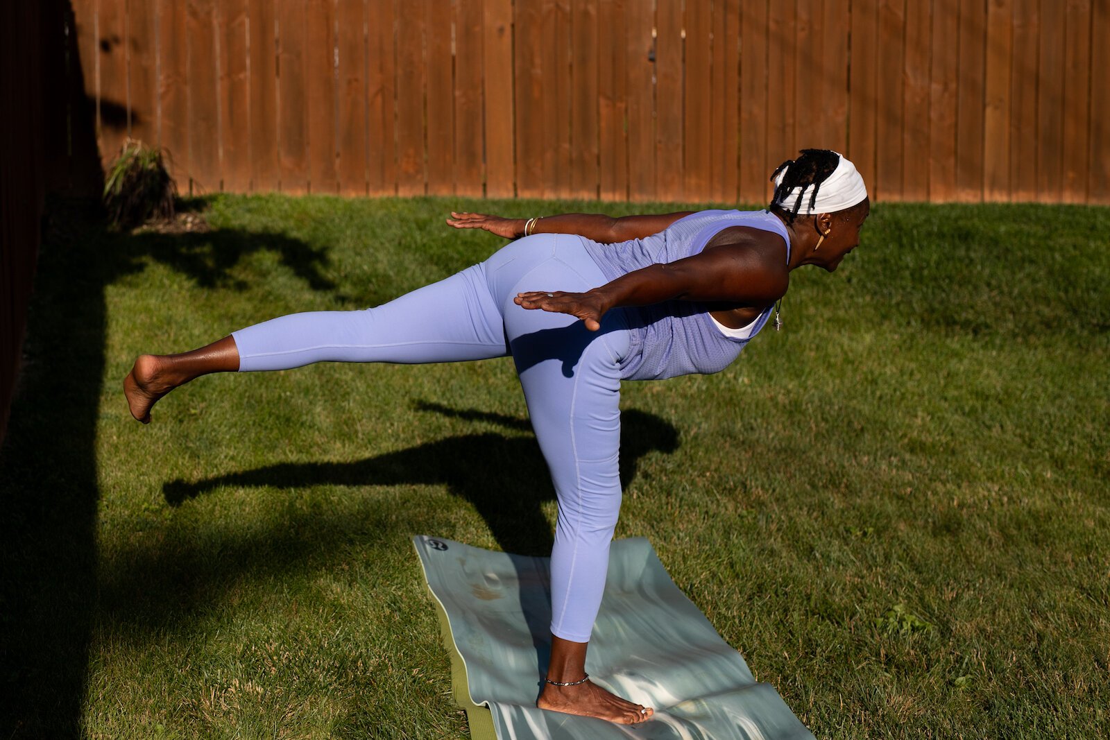 Diane Rogers, a longtime resident and current President of the Oxford Community Association, leads a yoga class in her backyard for her neighborhood and community drop-ins.