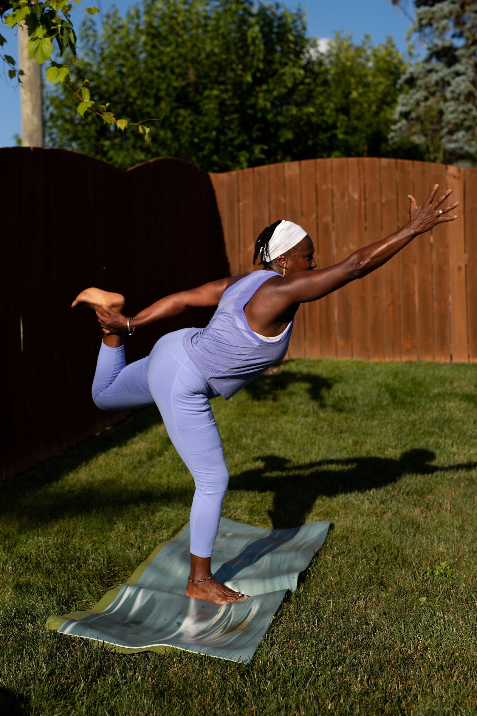 Diane Rogers, a longtime resident and current President of the Oxford Community Association, leads a yoga class in her backyard for her neighborhood and community drop-ins.
