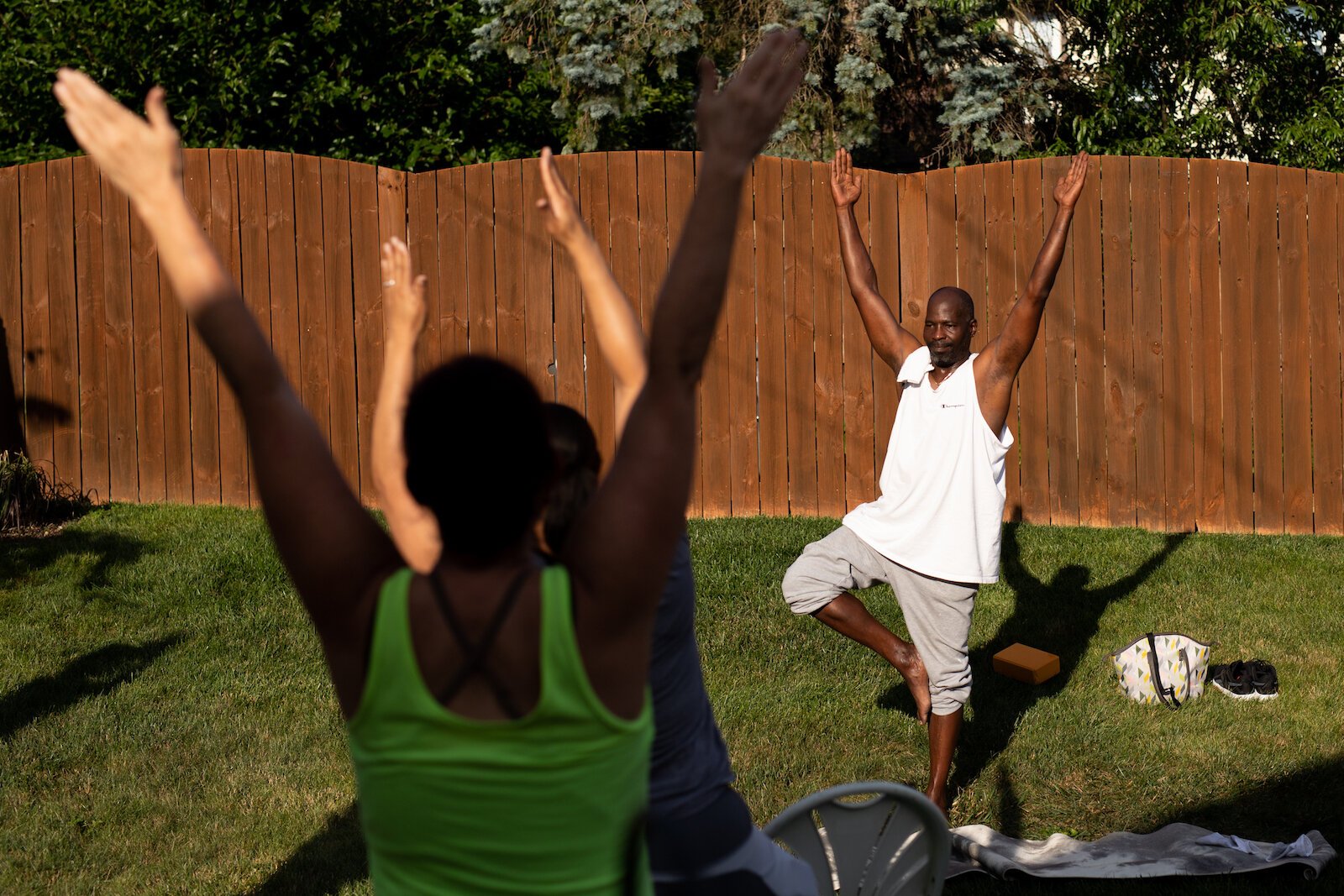 About eight men and women participate in a recent yoga class in Diane Rogers's backyard in South East Fort Wayne.