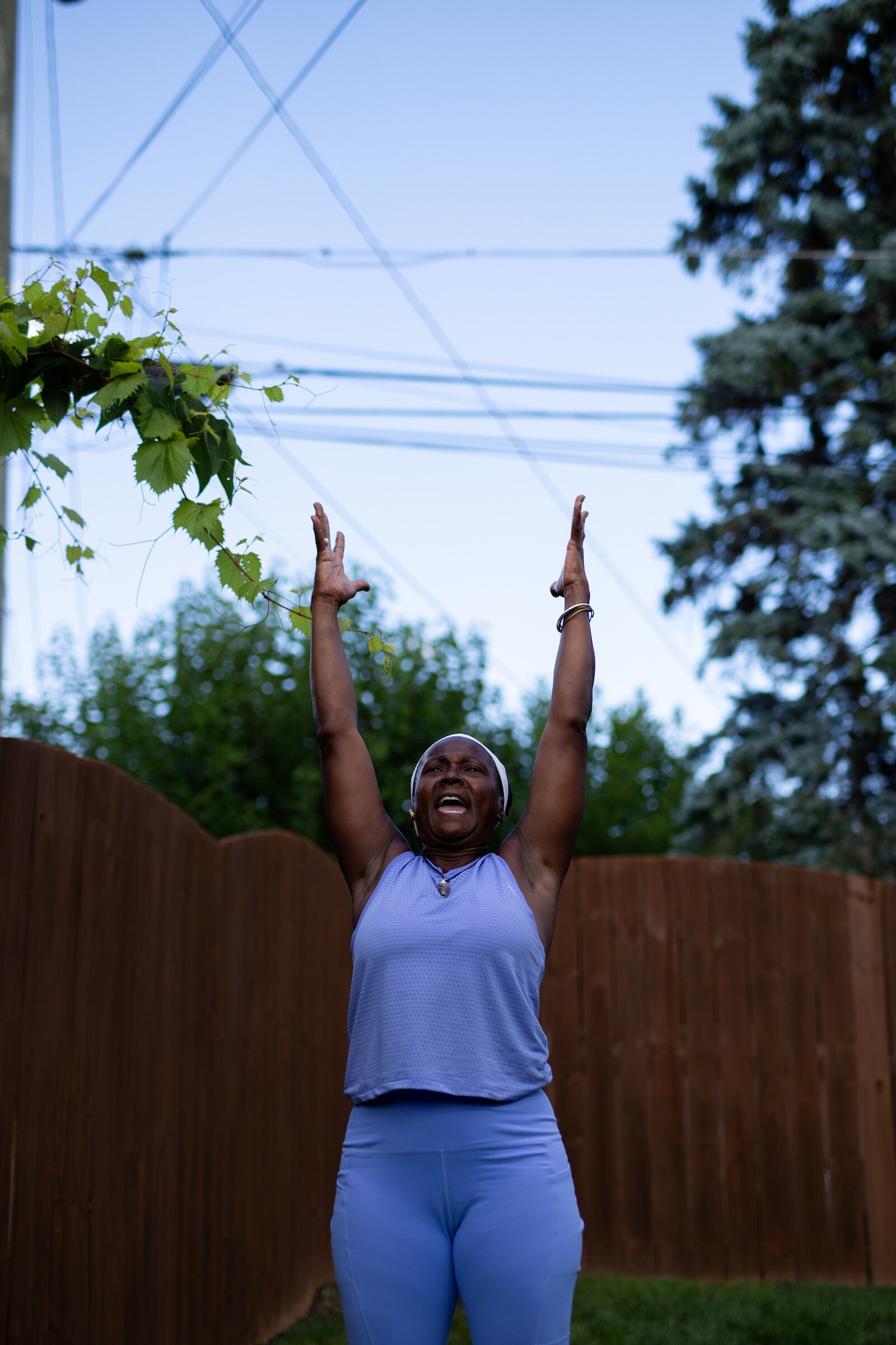 Diane Rogers, a longtime resident and current President of the Oxford Community Association, leads a yoga class in her backyard for her neighborhood and community drop-ins.