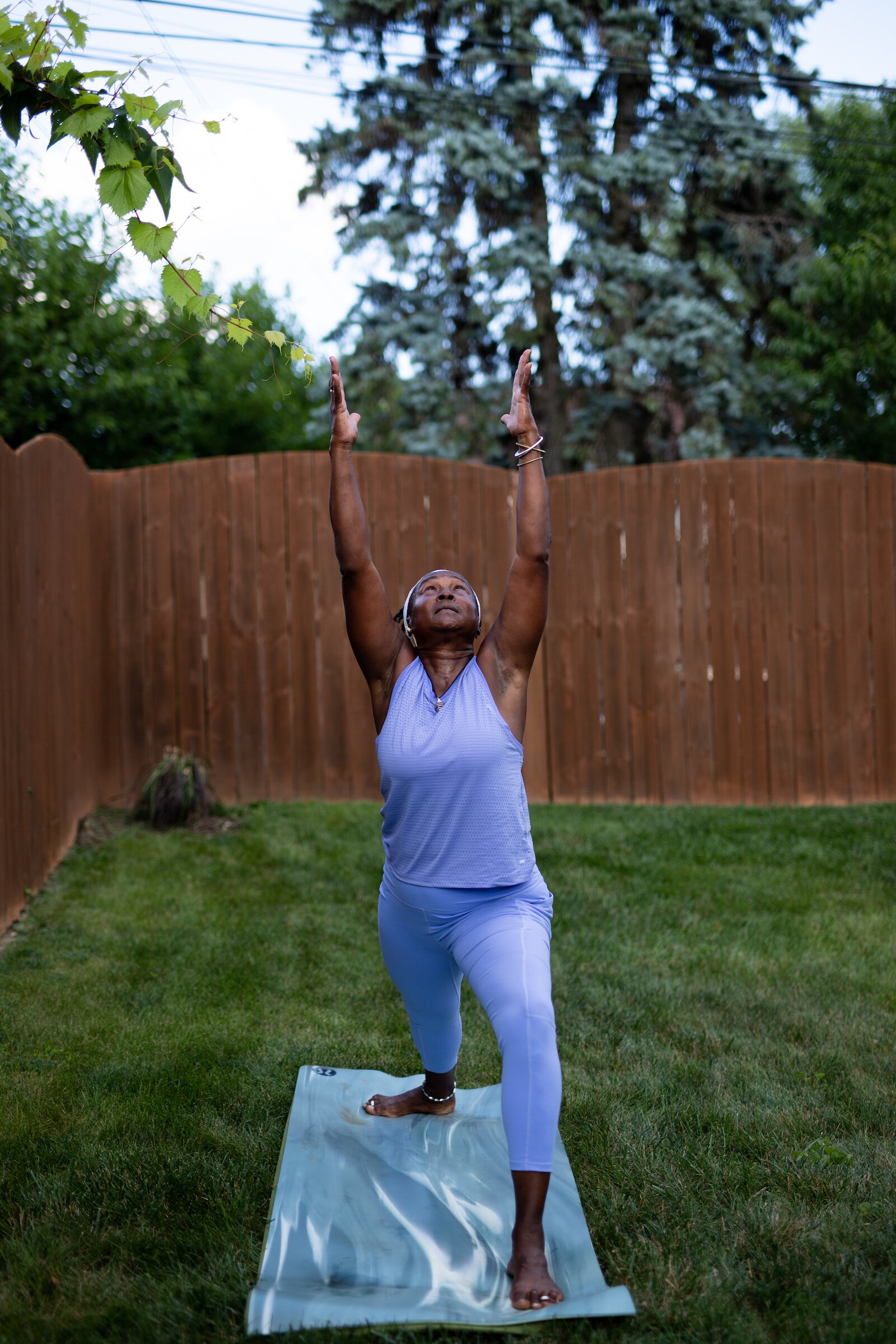 Diane Rogers, a longtime resident and current President of the Oxford Community Association, leads a yoga class in her backyard for her neighborhood and community drop-ins.