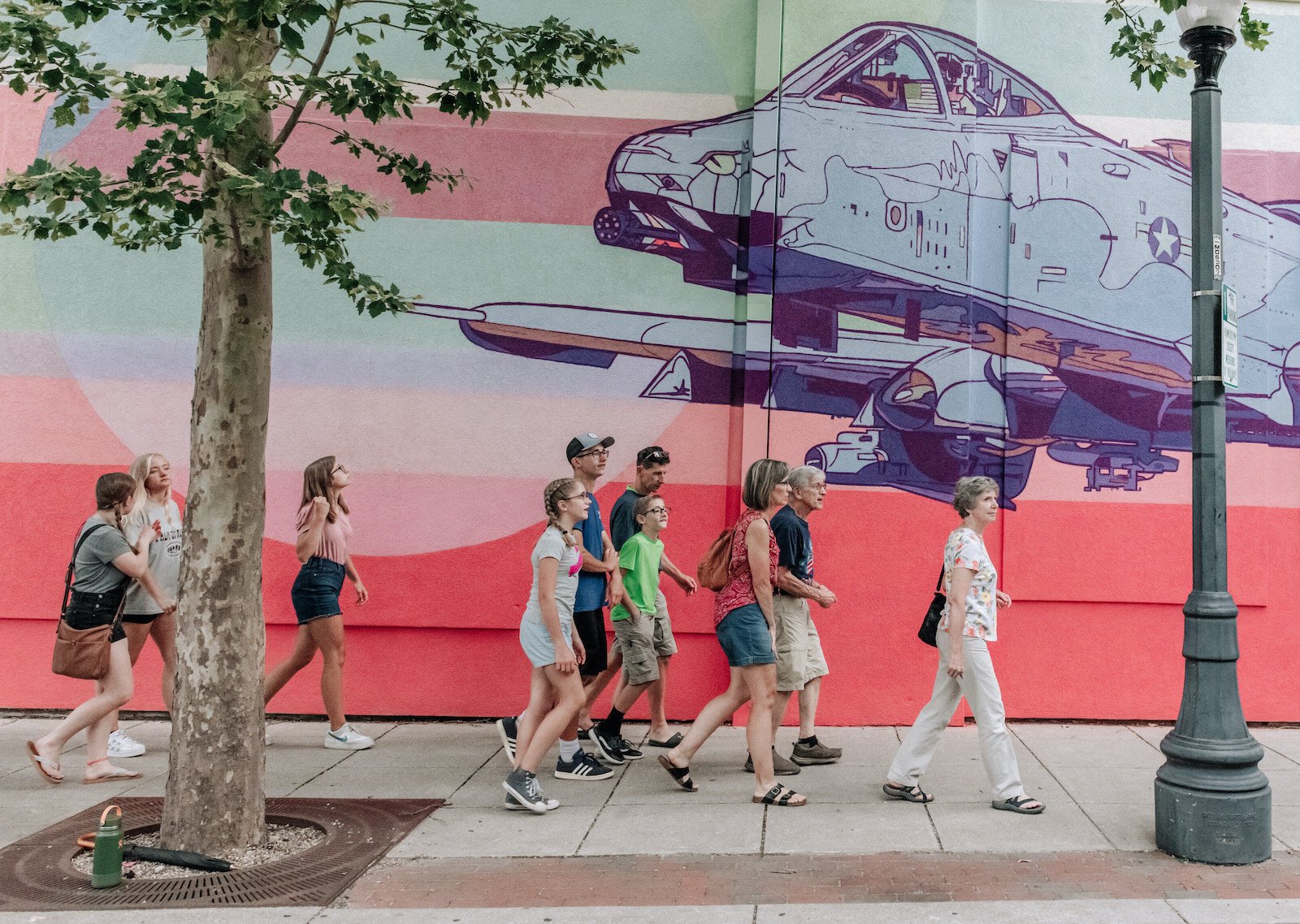 A group of Art Crawl attendees walk to another location Downtown.