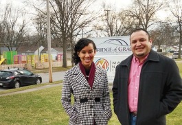 Réna Bradley and Pastor Javier Mondragon stand in front of a playground designed by local students working with Bridge of Grace.