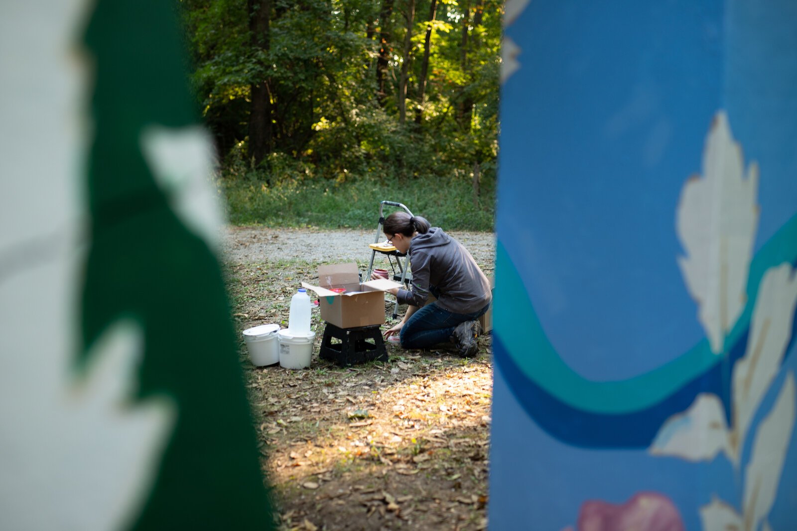 Suzanne Rhee works on her mural in Foster Park.