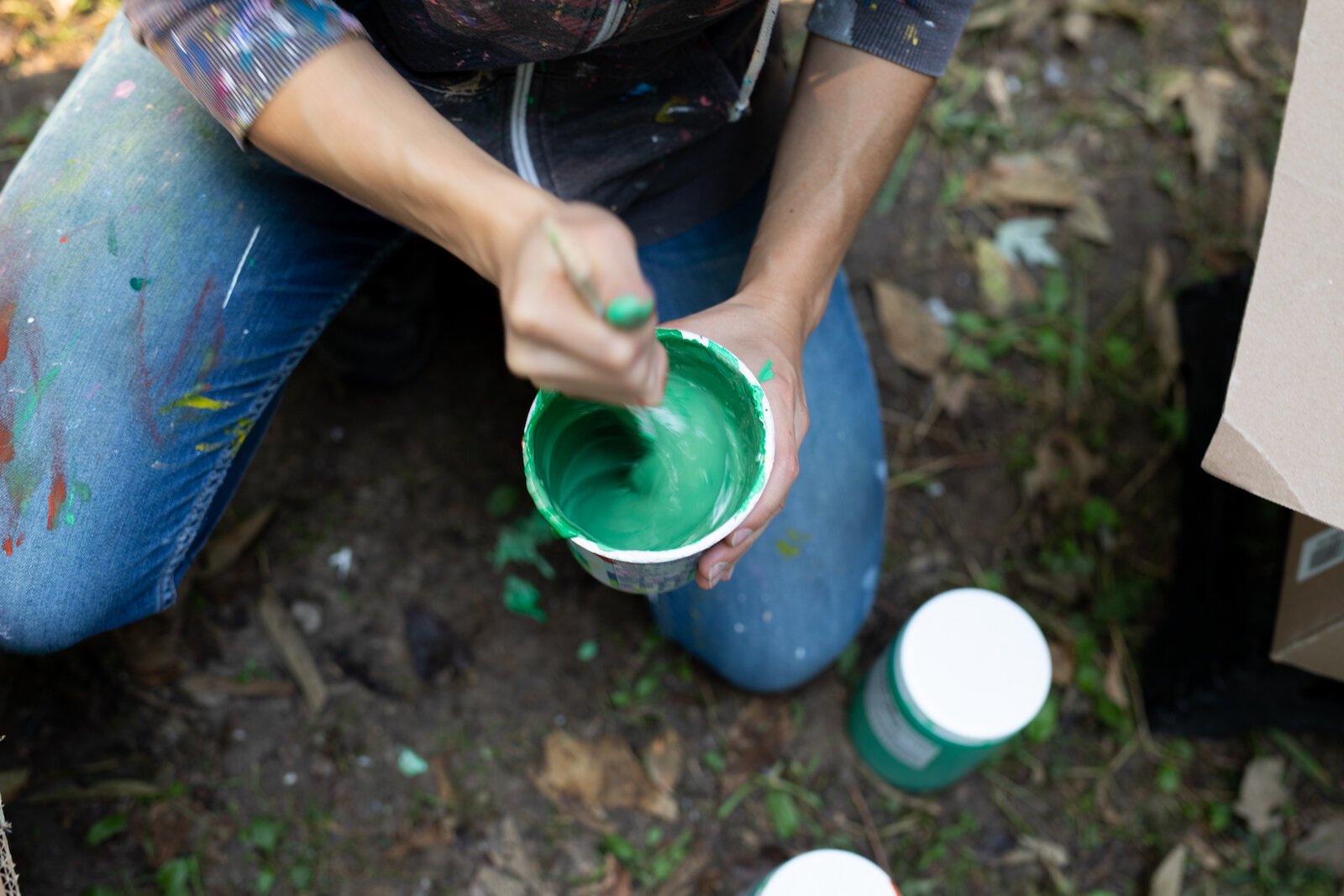 Suzanne Rhee works on her mural in Foster Park.