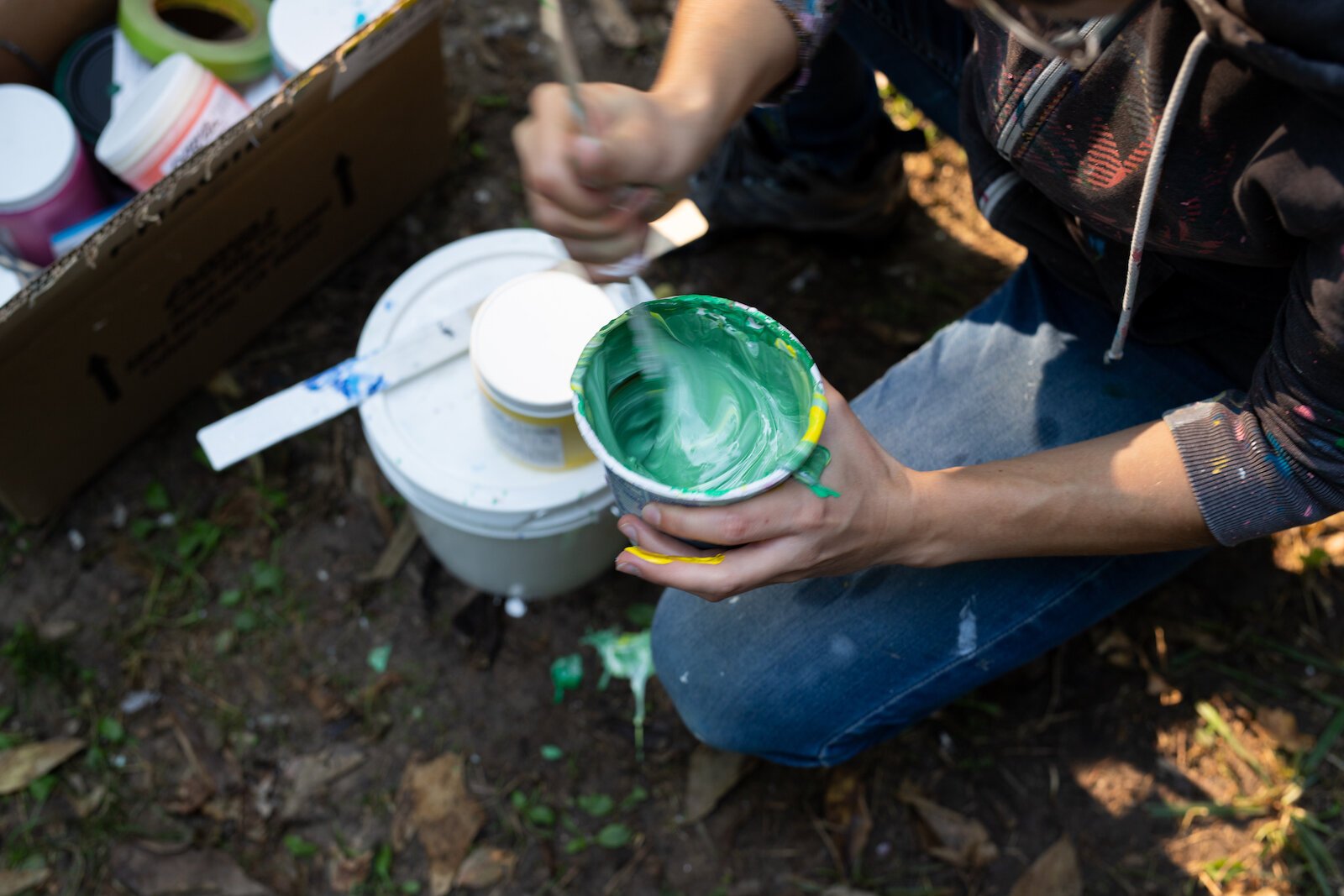 Suzanne Rhee works on her mural in Foster Park.