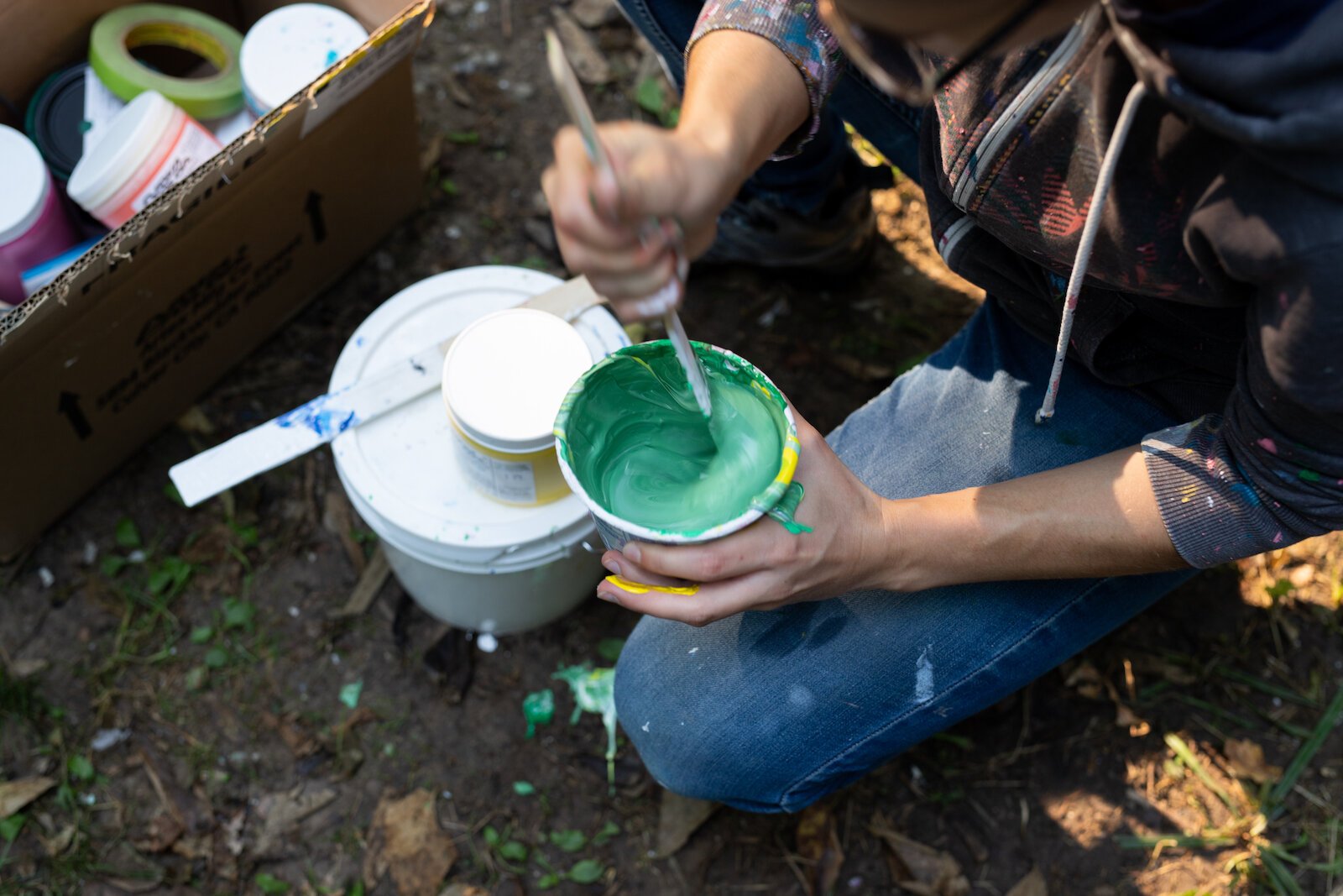 Suzanne Rhee works on her mural in Foster Park.