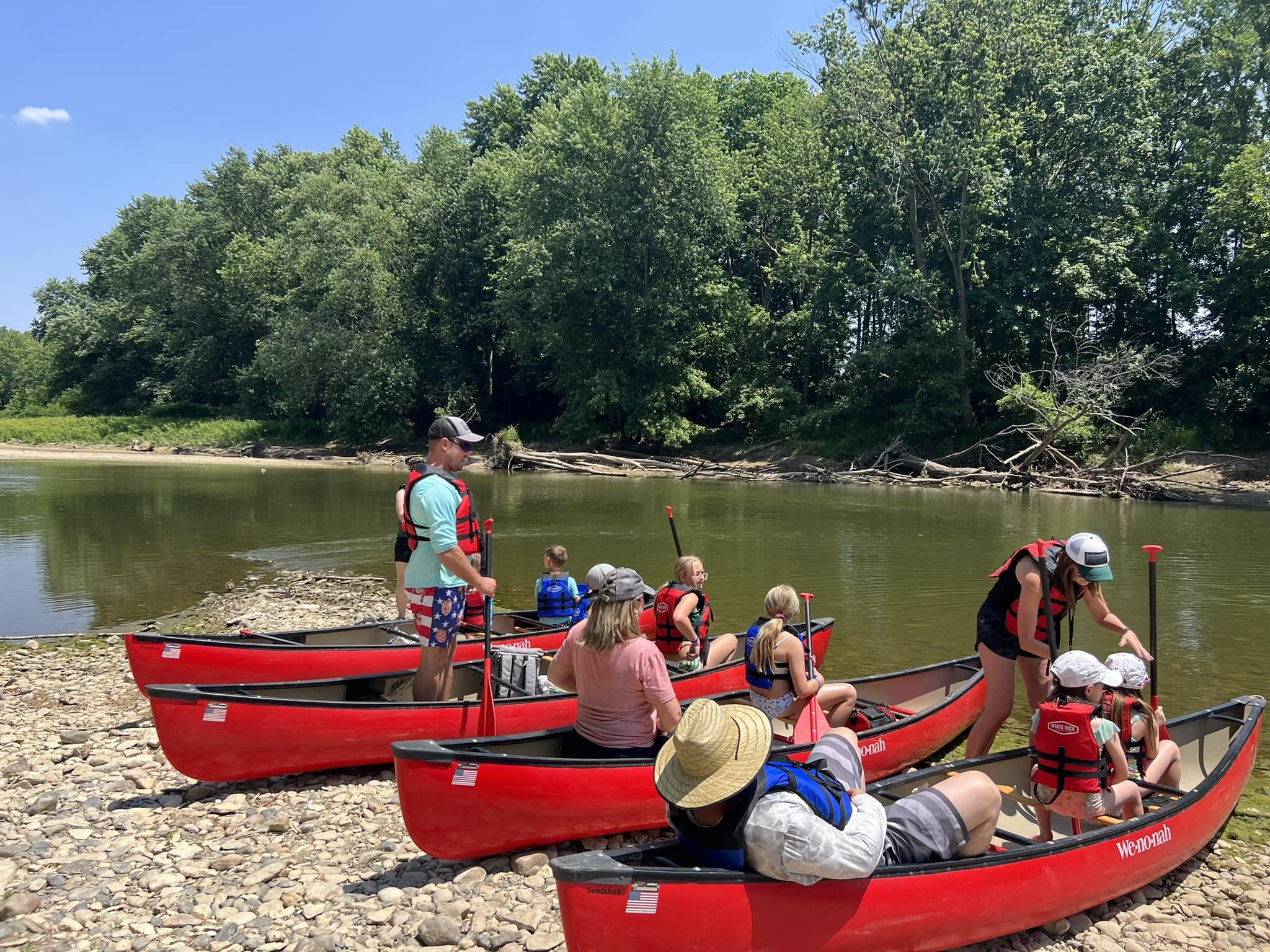 People prepare to canoe down the Wabash River.