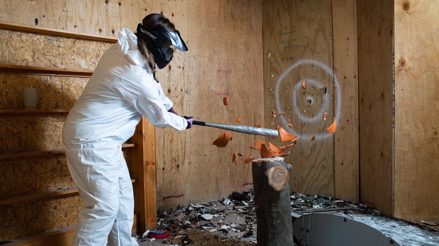 Abby Greutman hits a pot with a baseball bat at All the Rage.