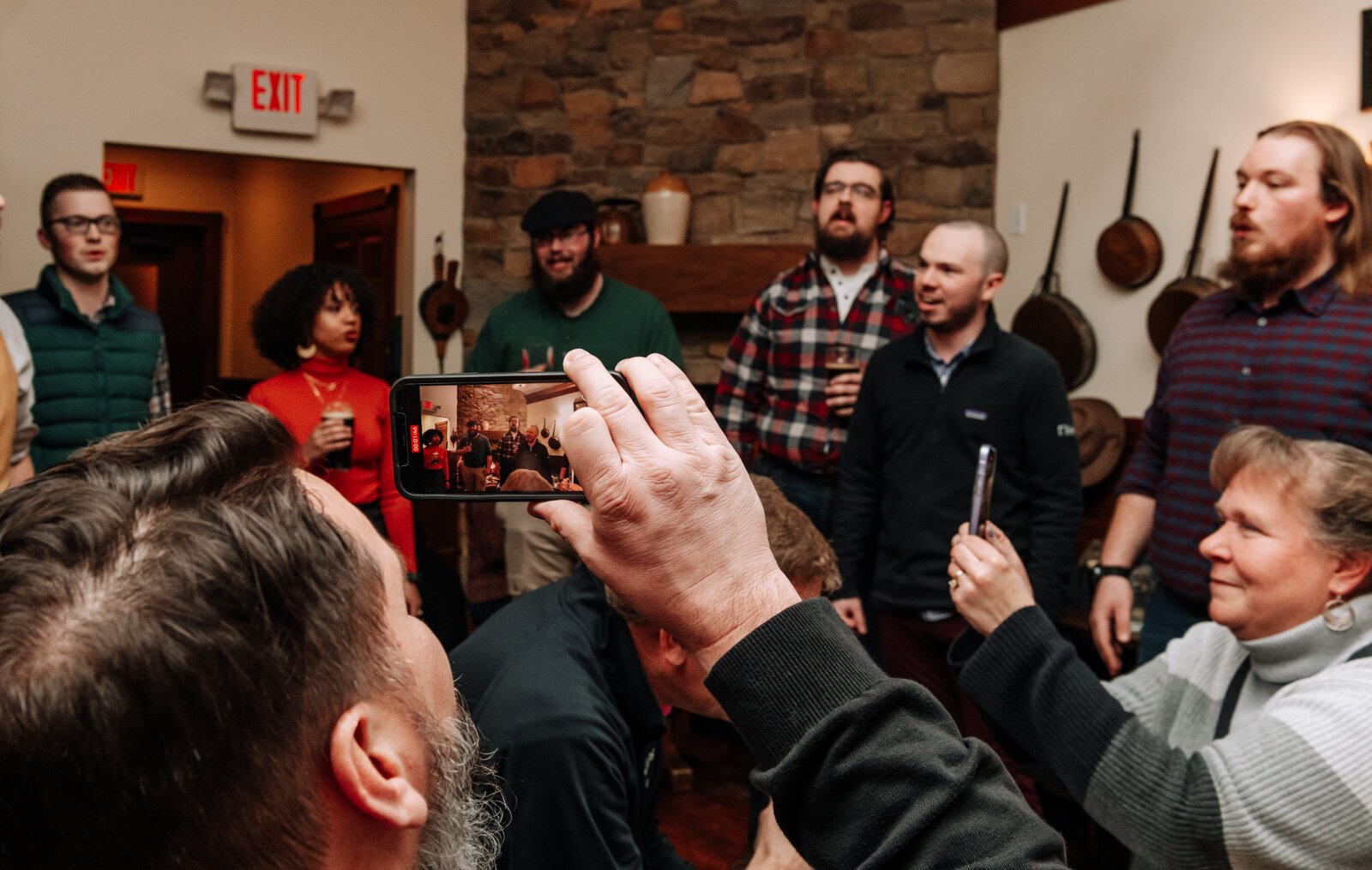 Crowd members grab video of a song during a performance of The Ragtag Bunch at J.K. O’ Donnell’s on February 24, 2022.