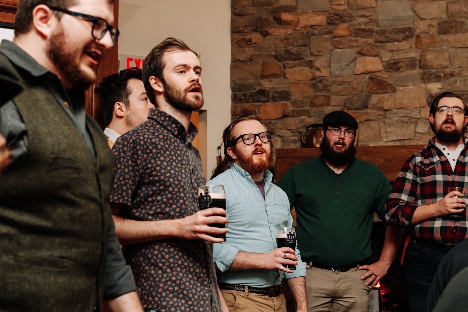 Members of The Ragtag Bunch sing while holding beers during a performance at J.K. O’ Donnell’s on February 24, 2022. 