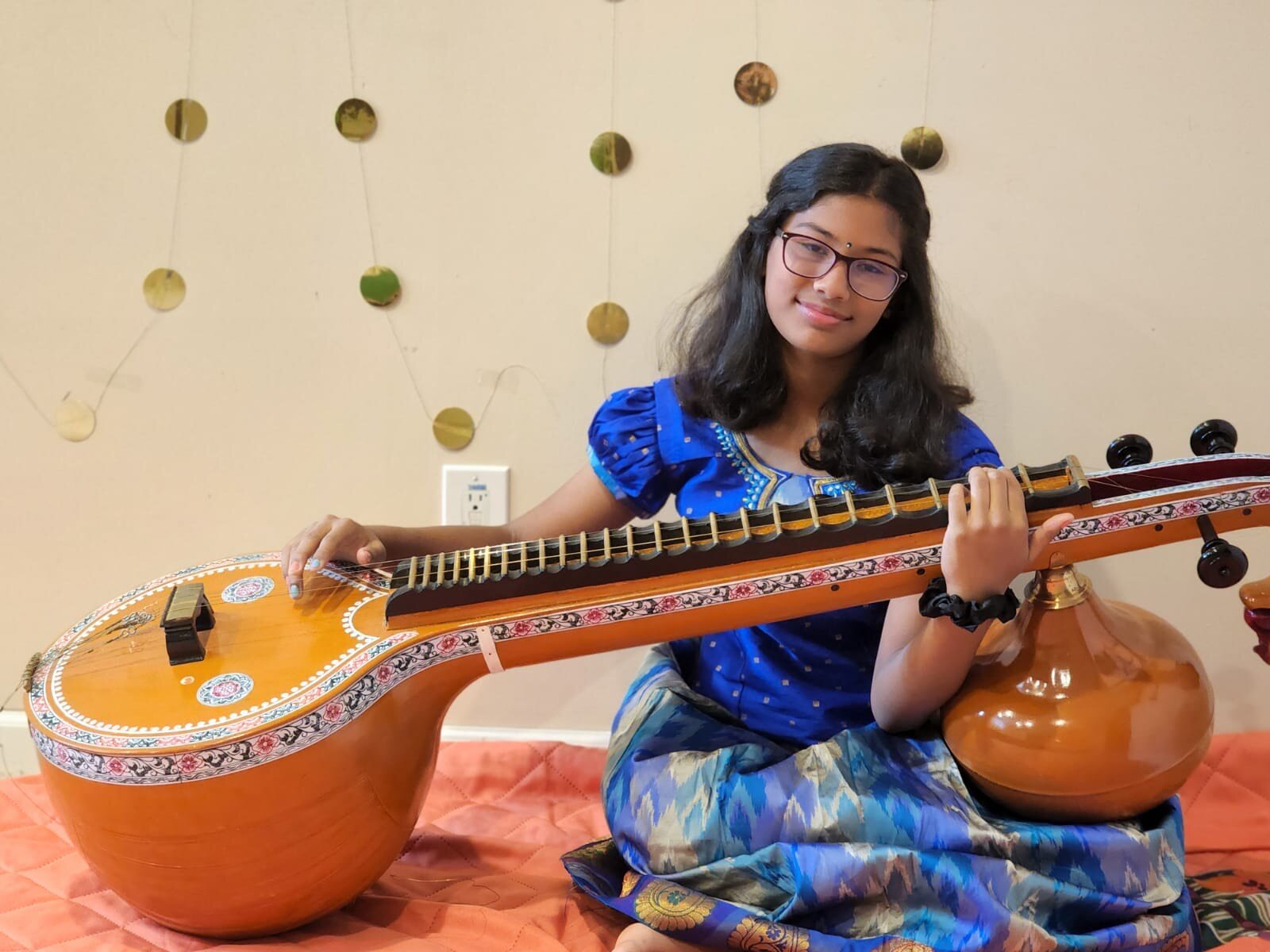 Sai Santhosh plays the Veena, a ancient Indian string instrument.
