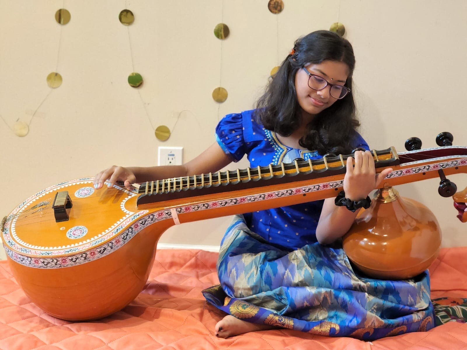 Sai Santhosh plays the Veena, a ancient Indian string instrument.