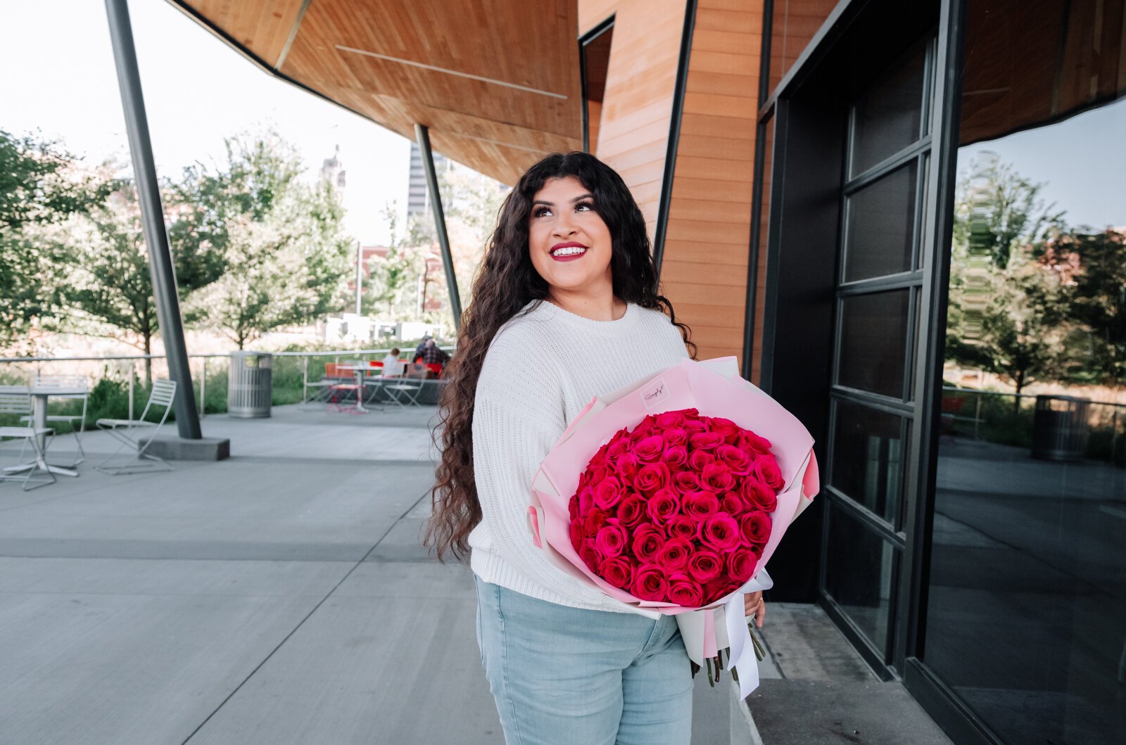 Samantha Cazares of Simply Charming holds her Classic 50 Rose Bouquet.