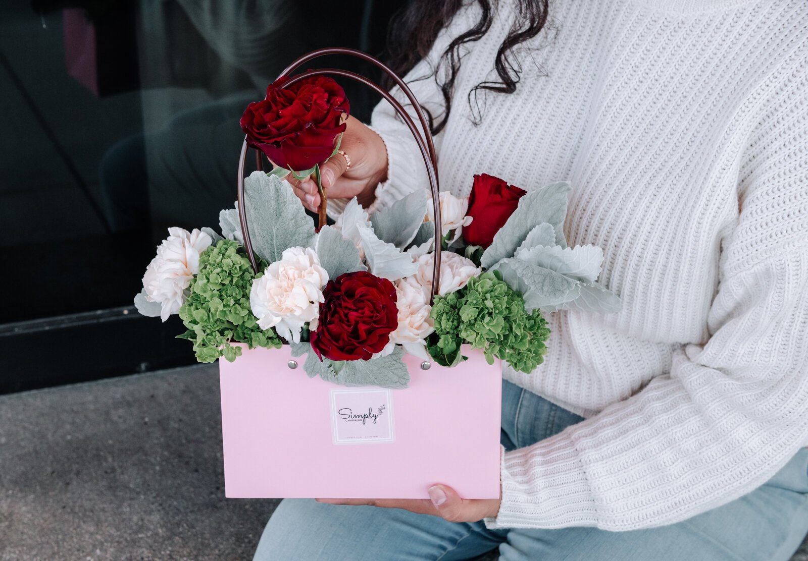 Samantha Cazares of Simply Charming works on arranging The Floral Purse.