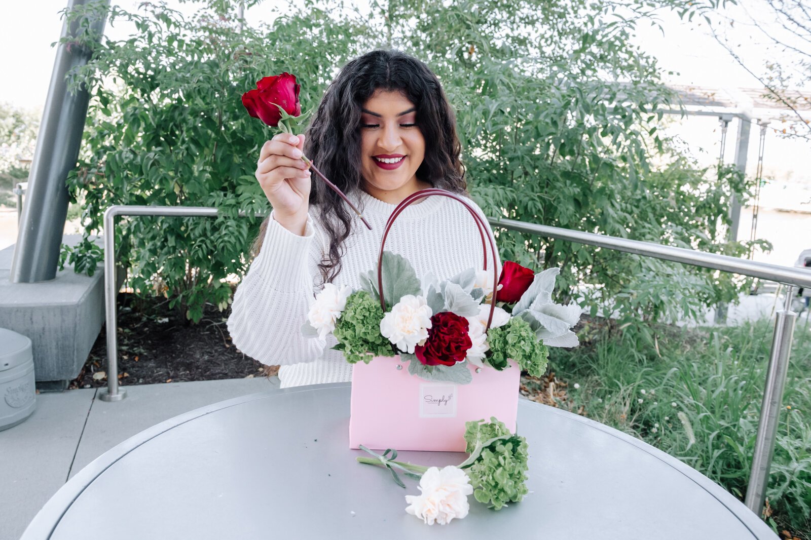 Samantha Cazares of Simply Charming works on arranging The Floral Purse.