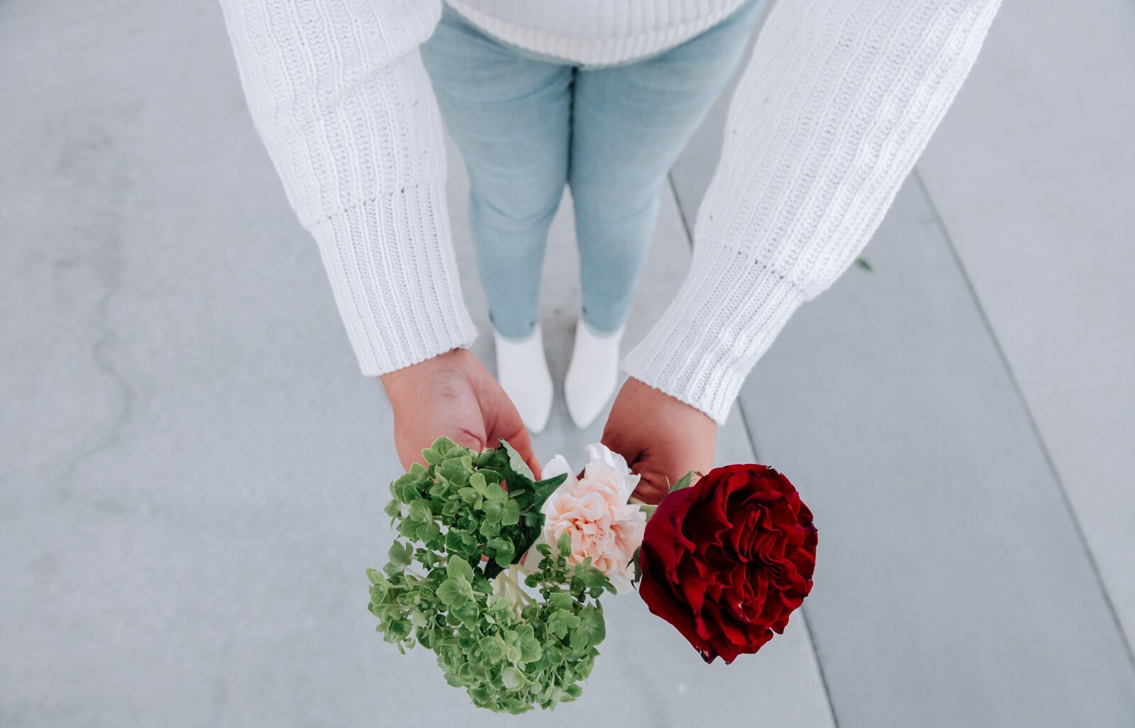 Samantha Cazares of Simply Charming holds up flowers that are part of The Floral Purse.