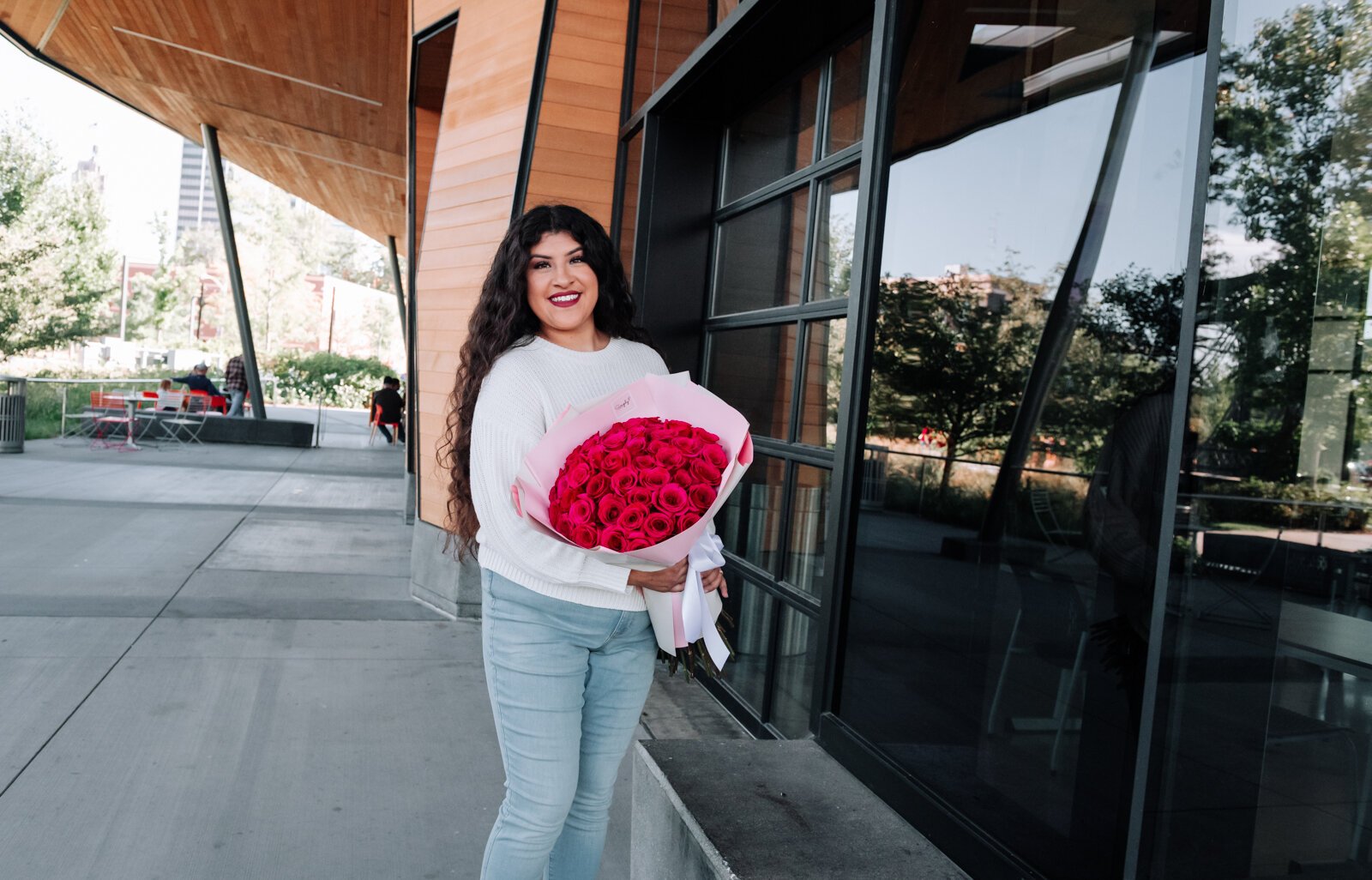 Samantha Cazares of Simply Charming holds her Classic 50 Rose Bouquet.