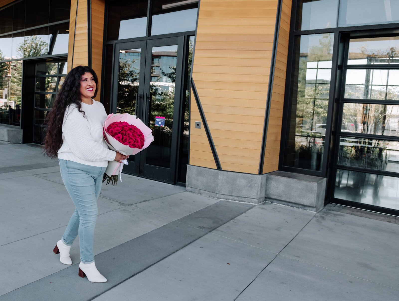 Samantha Cazares of Simply Charming holds her Classic 50 Rose Bouquet.