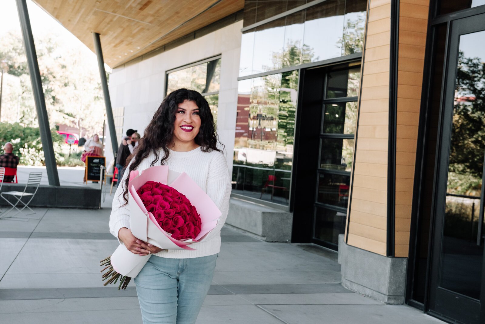 Samantha Cazares of Simply Charming holds her Classic 50 Rose Bouquet.