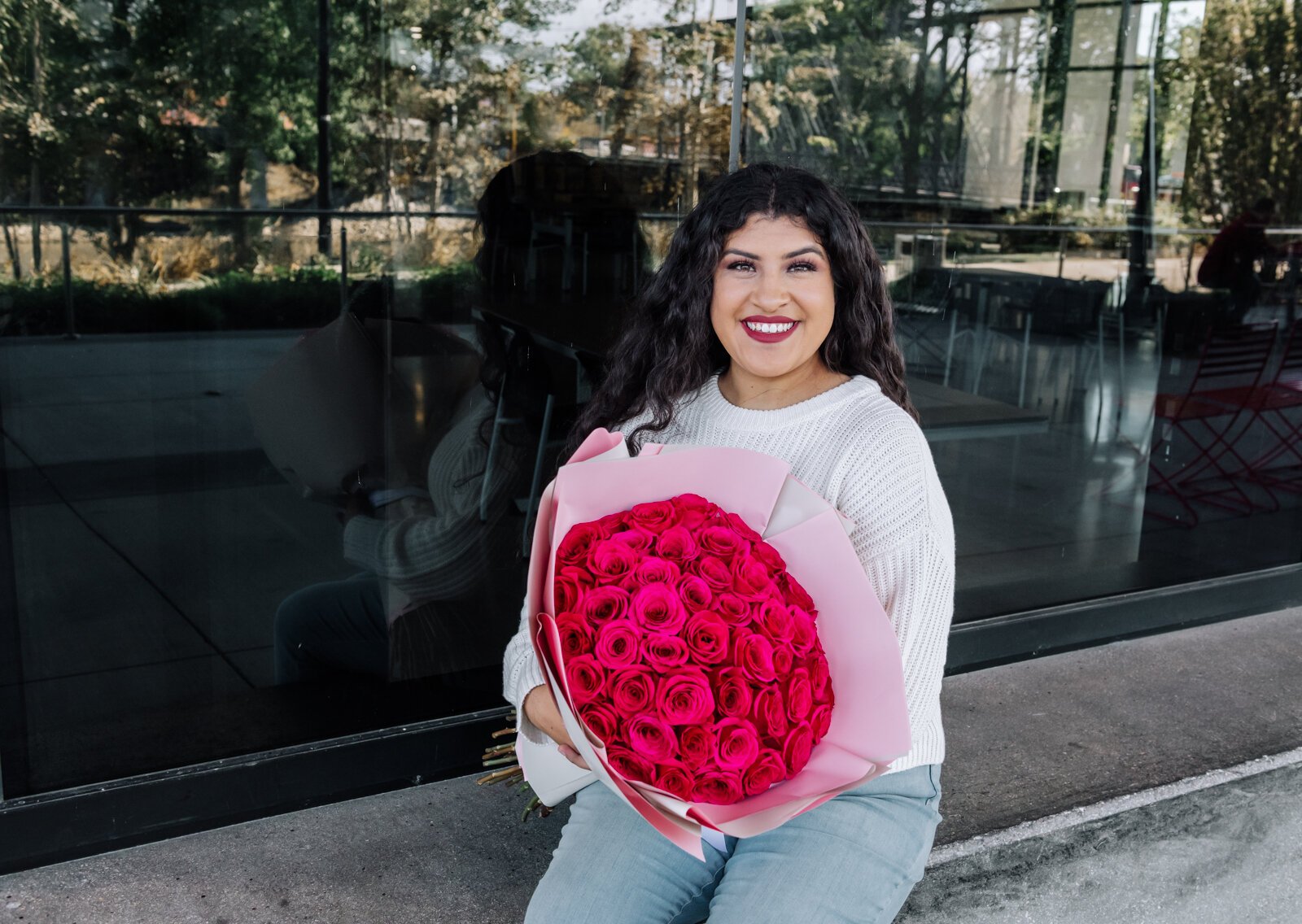 Samantha Cazares of Simply Charming holds her Classic 50 Rose Bouquet.