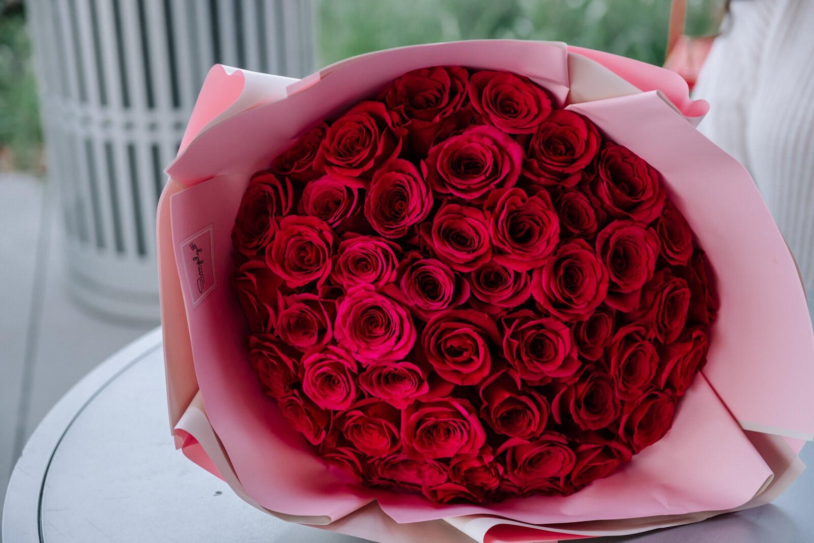 Samantha Cazares of Simply Charming holds her Classic 50 Rose Bouquet.