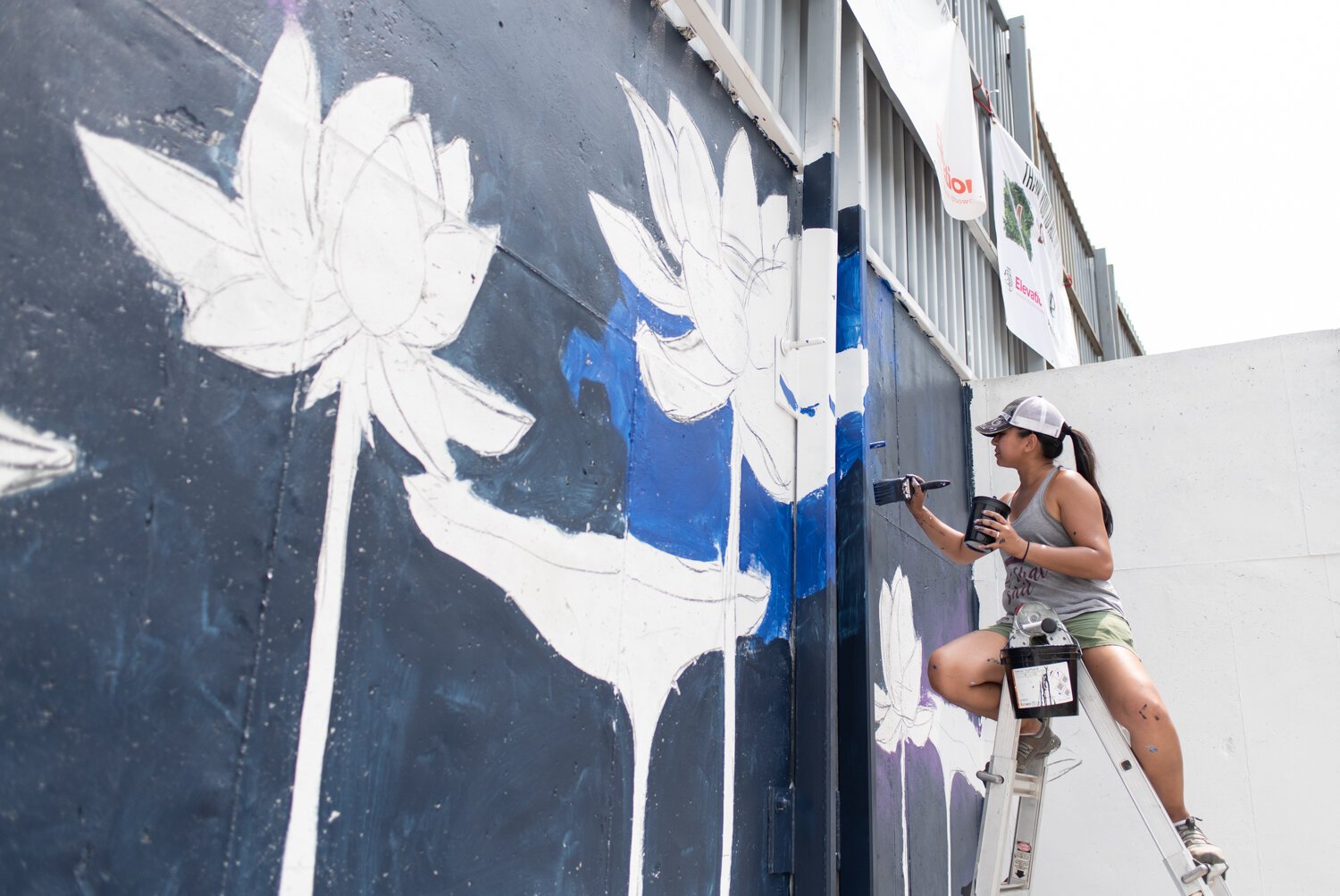 Nancy Fritz works on her mural during "Elevation. A Summit City Mural Showcase" on the 2400 block of Central Dr. in Fort Wayne.