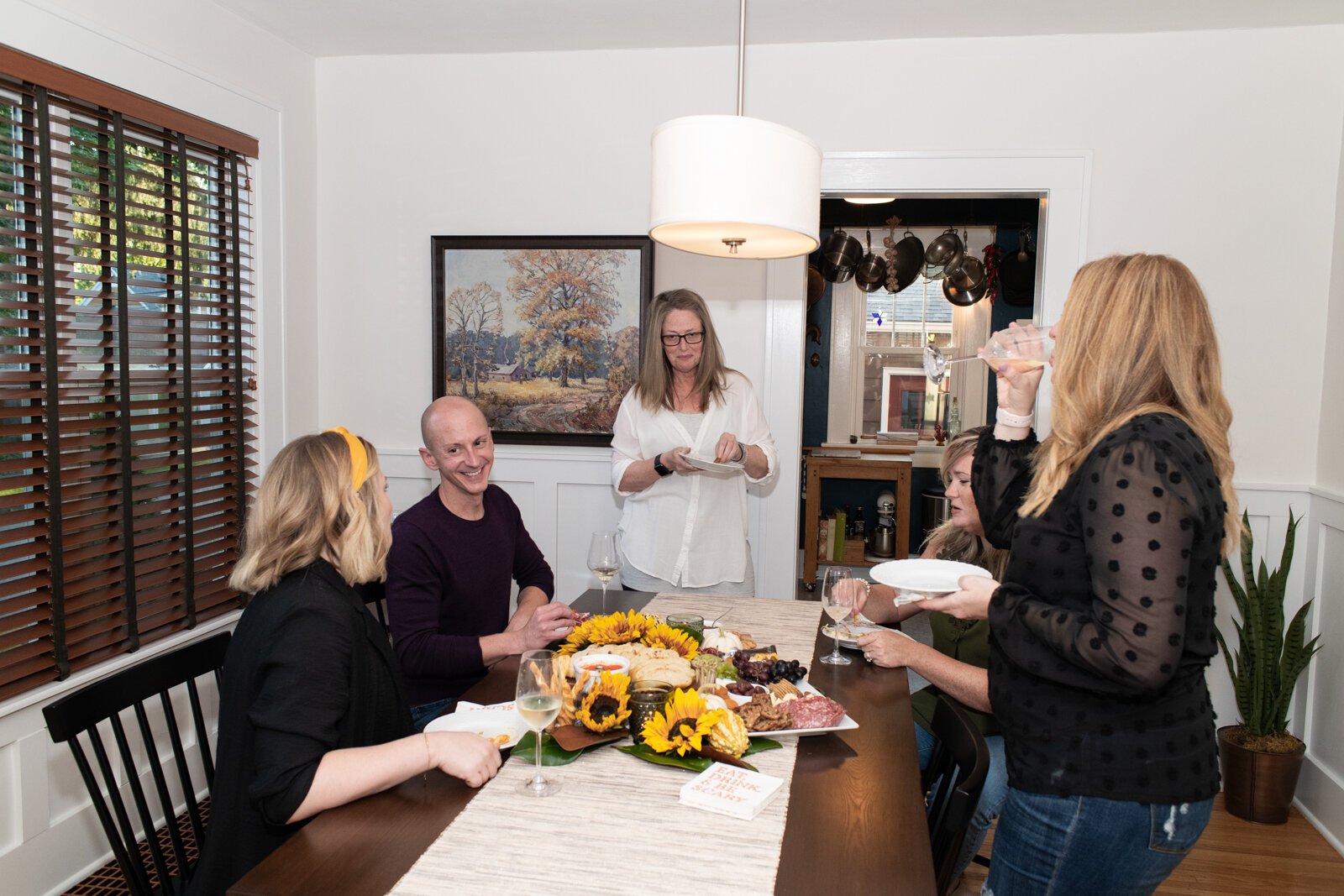 Kevin Christon spends time with friends in the dining room of his home in The '05.