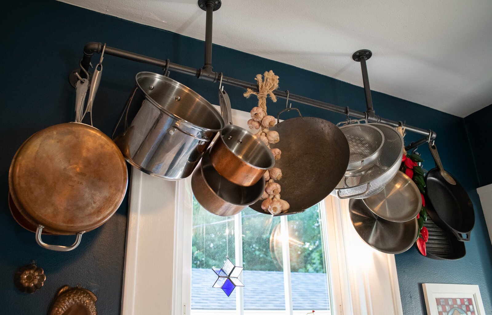 Hanging pots and pans maximizes space in a small kitchen.
