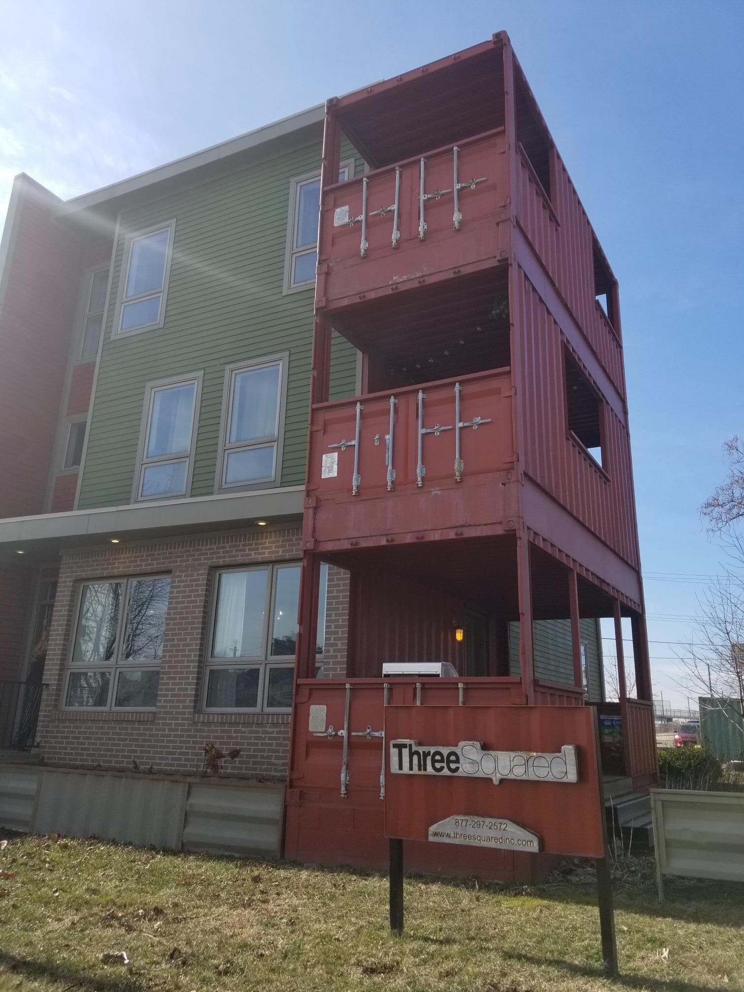 Housing in Detroit, Mich., that utilizes shipping containers as porches and patios.