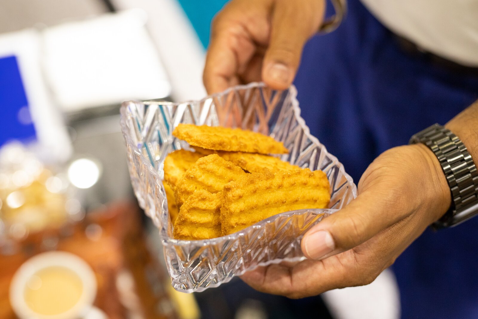 Singh shares tea cookies with guests.