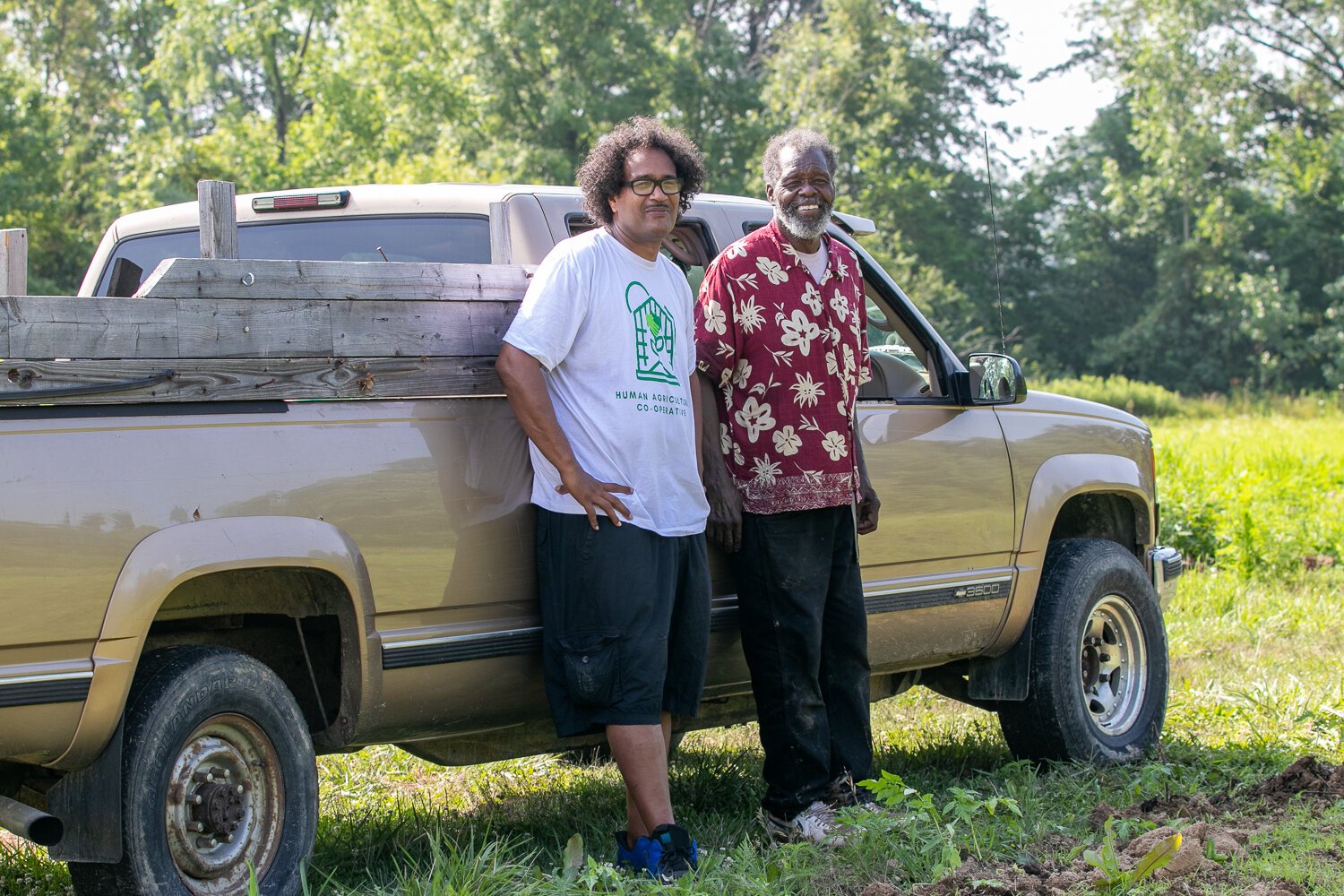 Ty Simmons, left, of the Human Agricultural Cooperative and Ephraim Smiley, right, of Smiley’s Garden Angels tend the community urban farm at 2512 E. Tillman Rd.