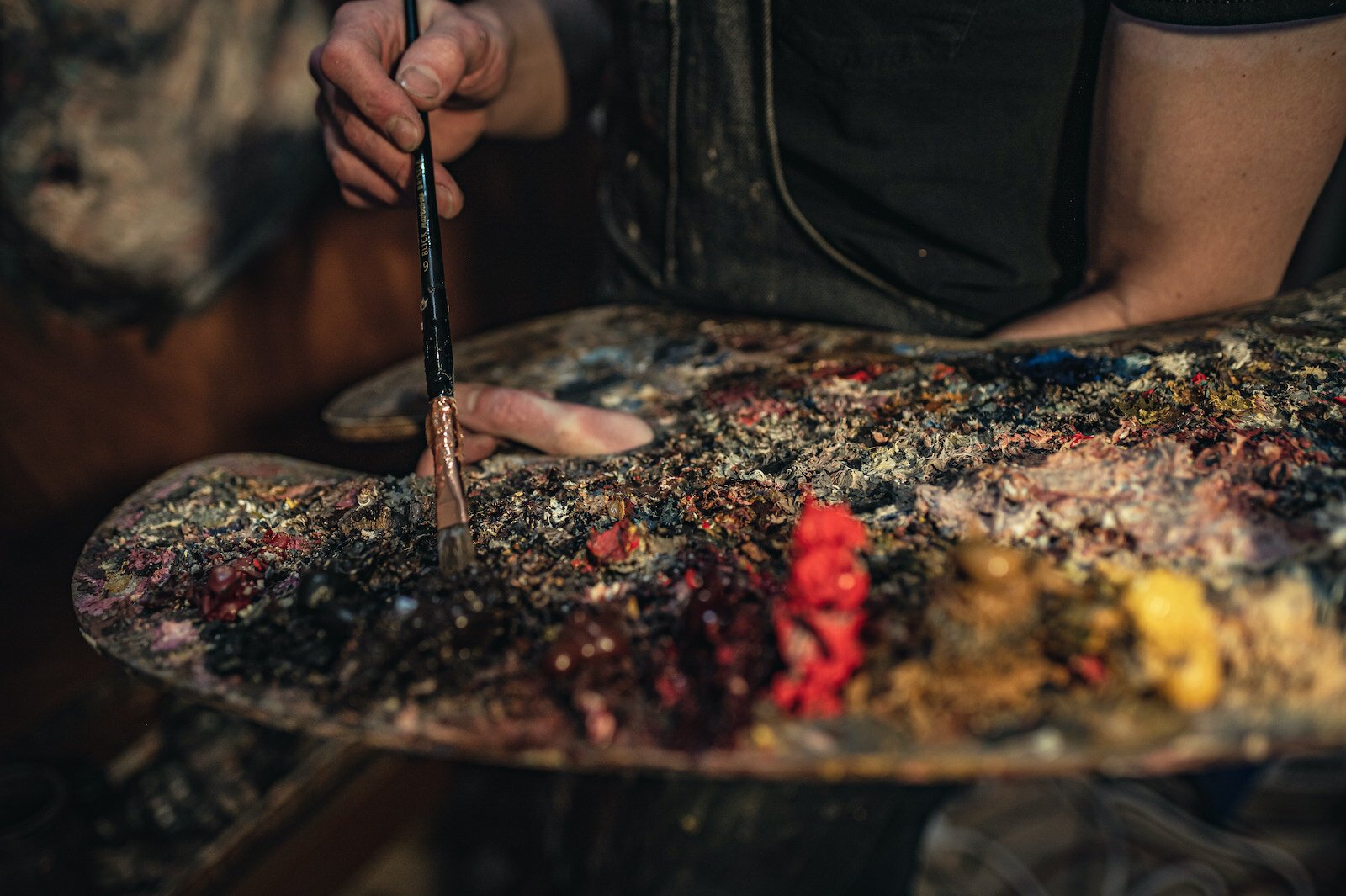 Artist Peter Lupkin works on a painting in studio.