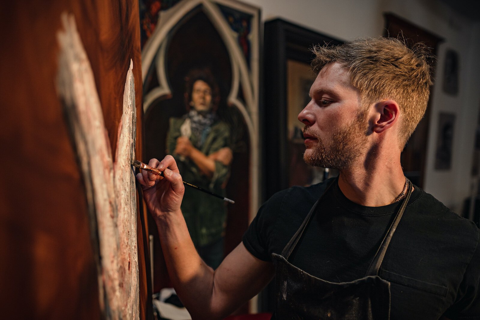 Artist Peter Lupkin works on a painting in studio.